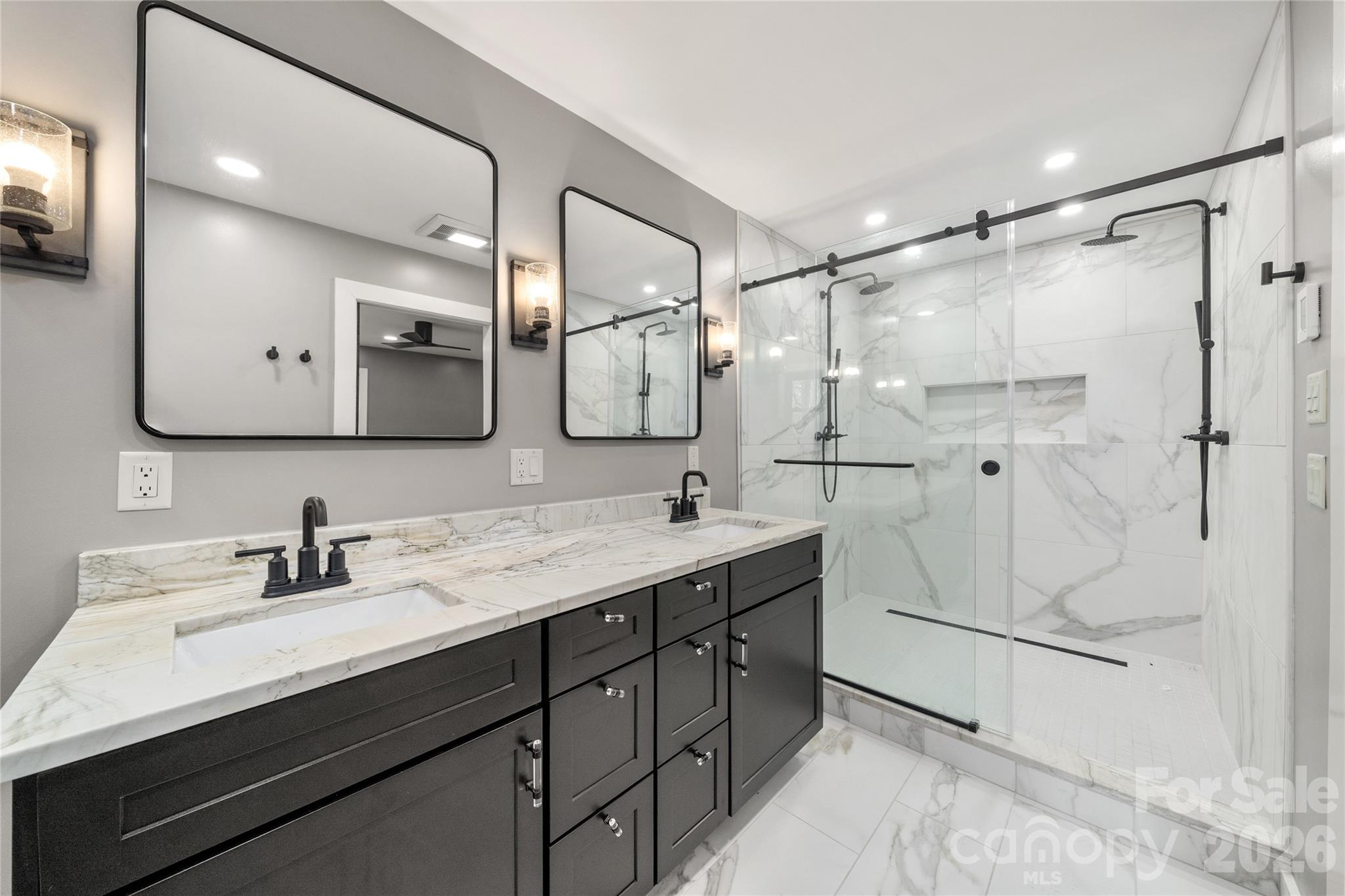 The 2nd full bath offers spa-inspired finishes and thoughtful upgrades throughout. - 453 Friendly Acres Drive, Waynesville