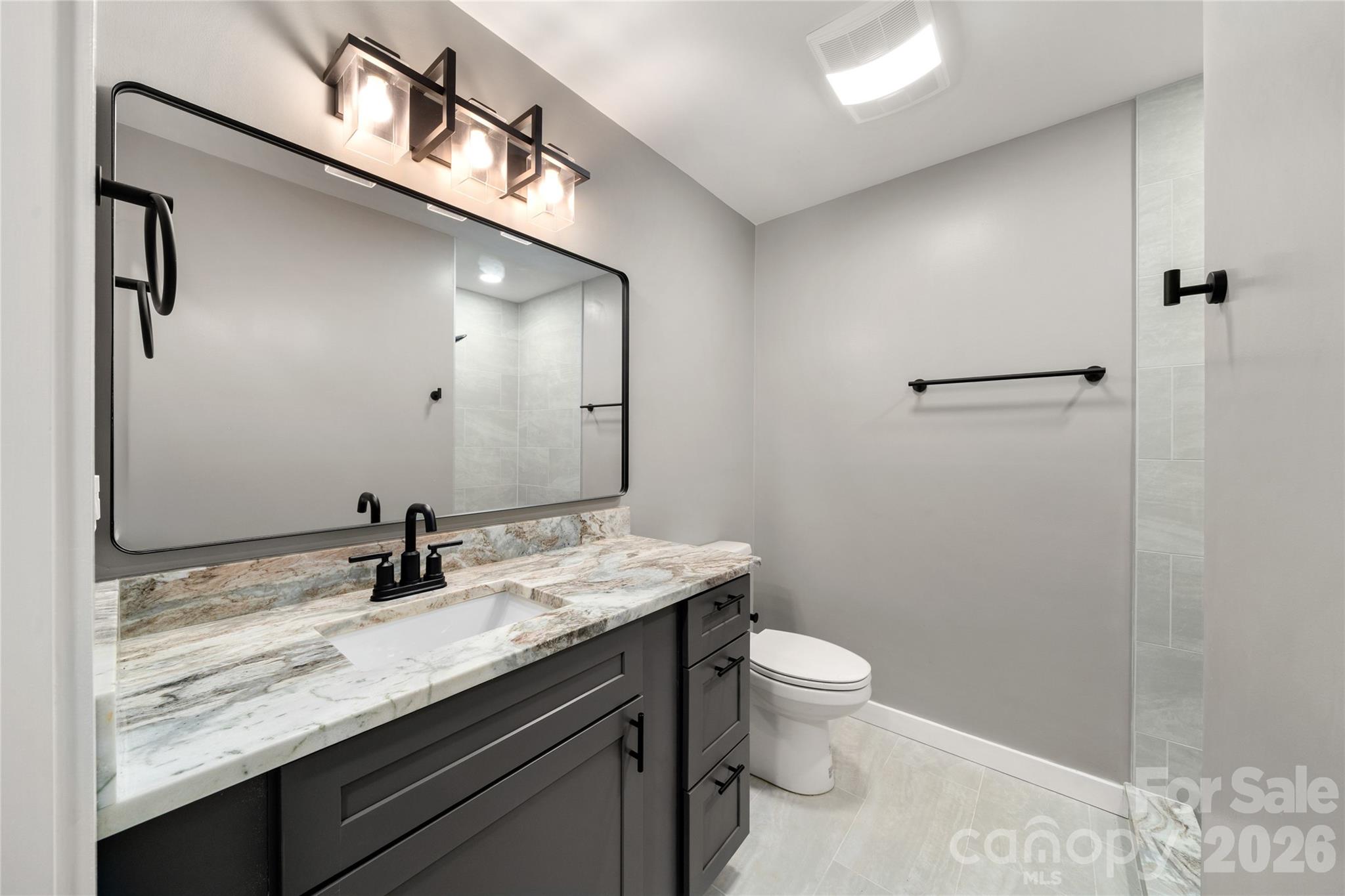 Beautifully renovated 3rd bath with modern fixtures and finishes. - 453 Friendly Acres Drive, Waynesville