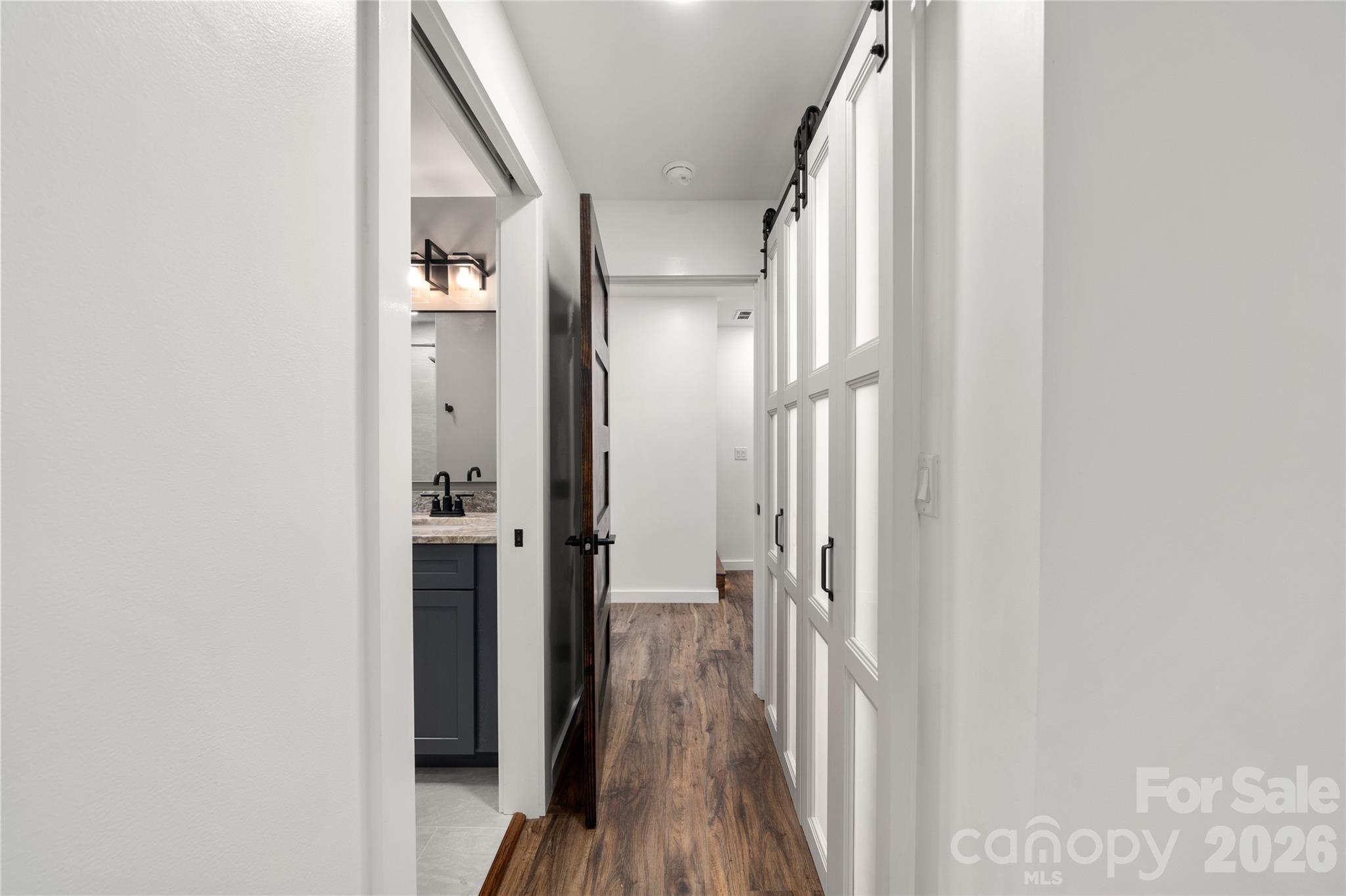 Downstairs hallway with new flooring, lighting and doors - 453 Friendly Acres Drive, Waynesville