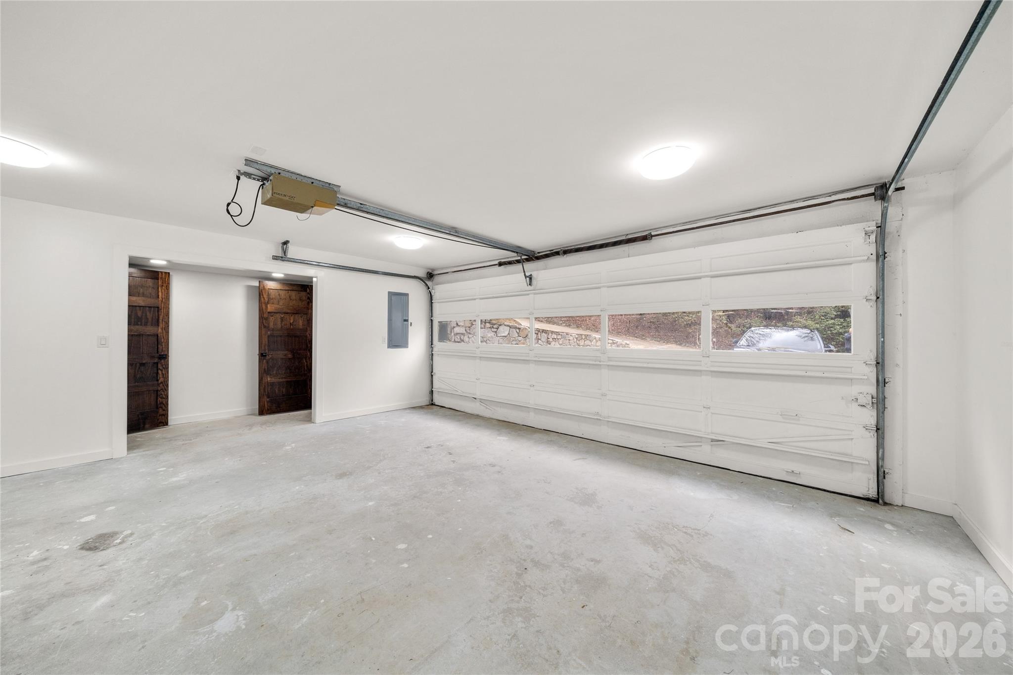 Spacious two-car garage with room for storage and mountain gear. - 453 Friendly Acres Drive, Waynesville