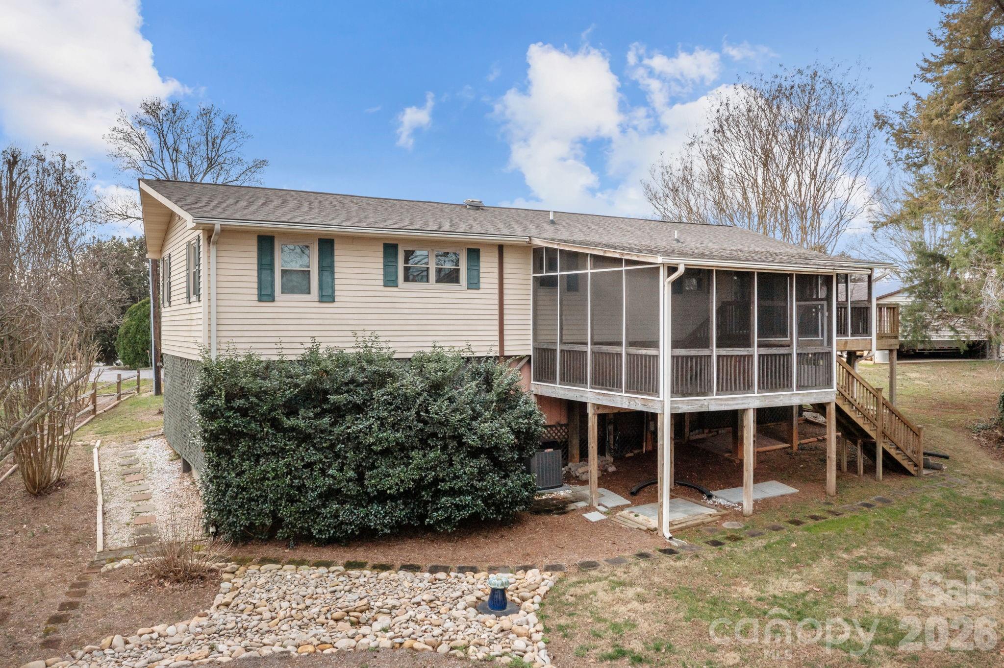 Rear of home. Enjoy time on screened in porches viewing the large back yard and views of the lake certain times of the year. - 4278 Harbor Lane, Sherrills Ford