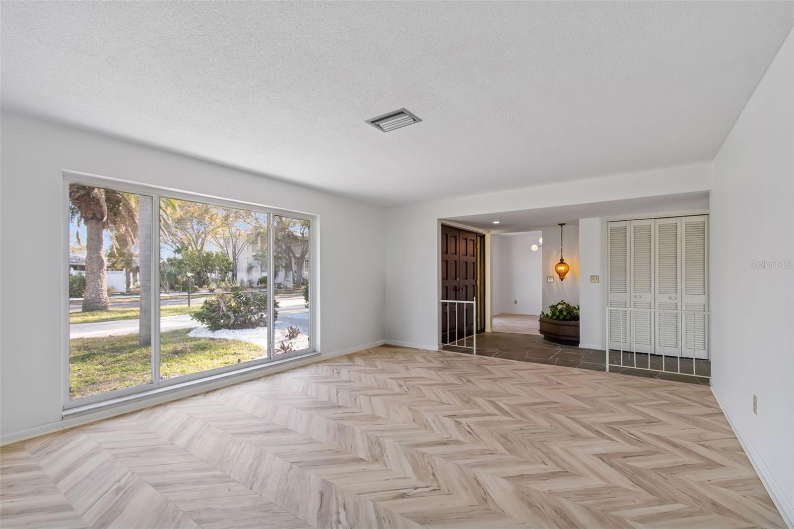 Another view of Living Room..check those new floors and fresh white paint throughout - 4415 CLEARWATER HARBOR DR N, LARGO