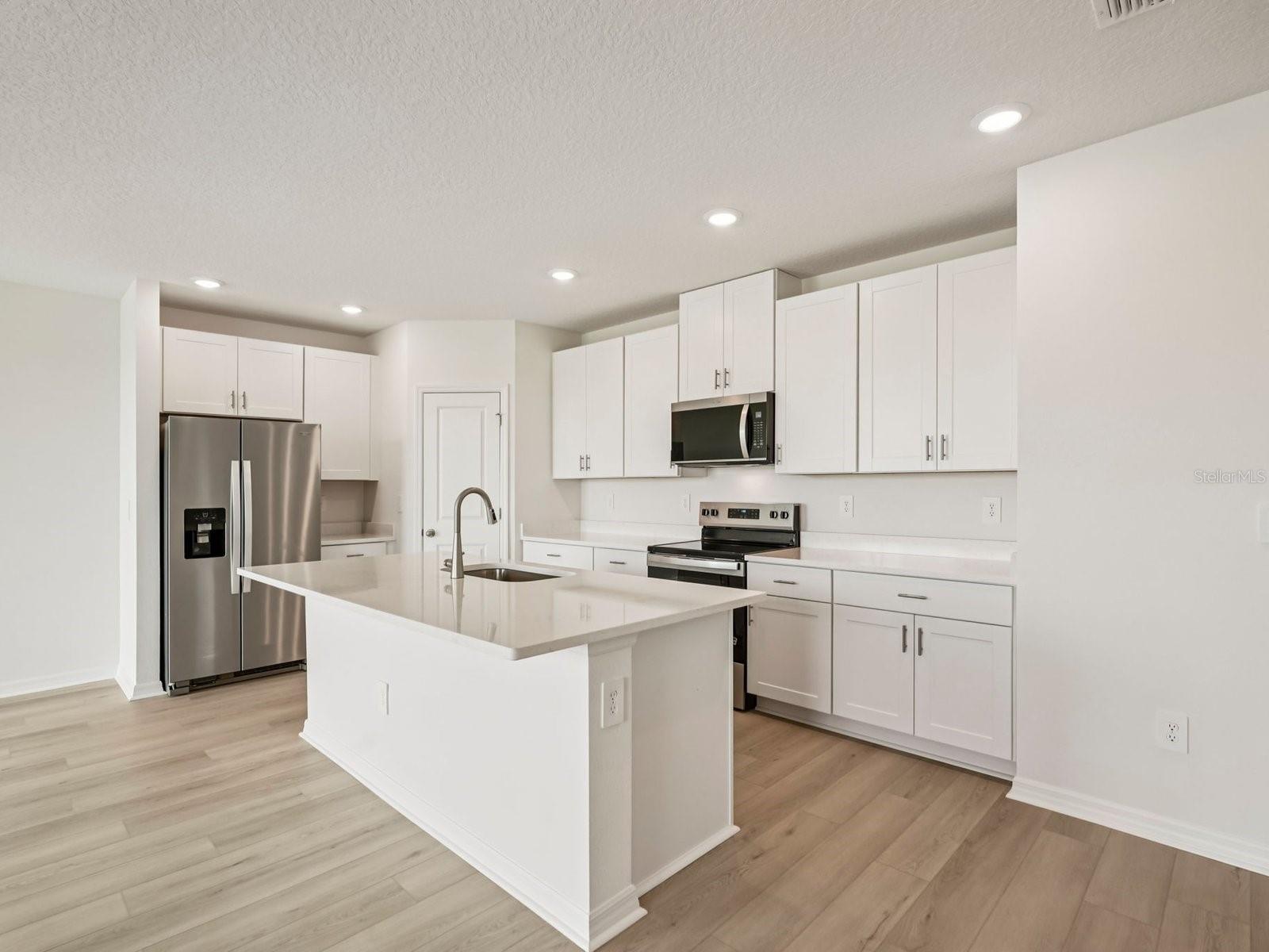 Interior photos are not of the actual home but are photos of the builder home with the same floorplan with similar interior finishes and features. - 10432 ABUNDANCE GROVE WAY, PARRISH