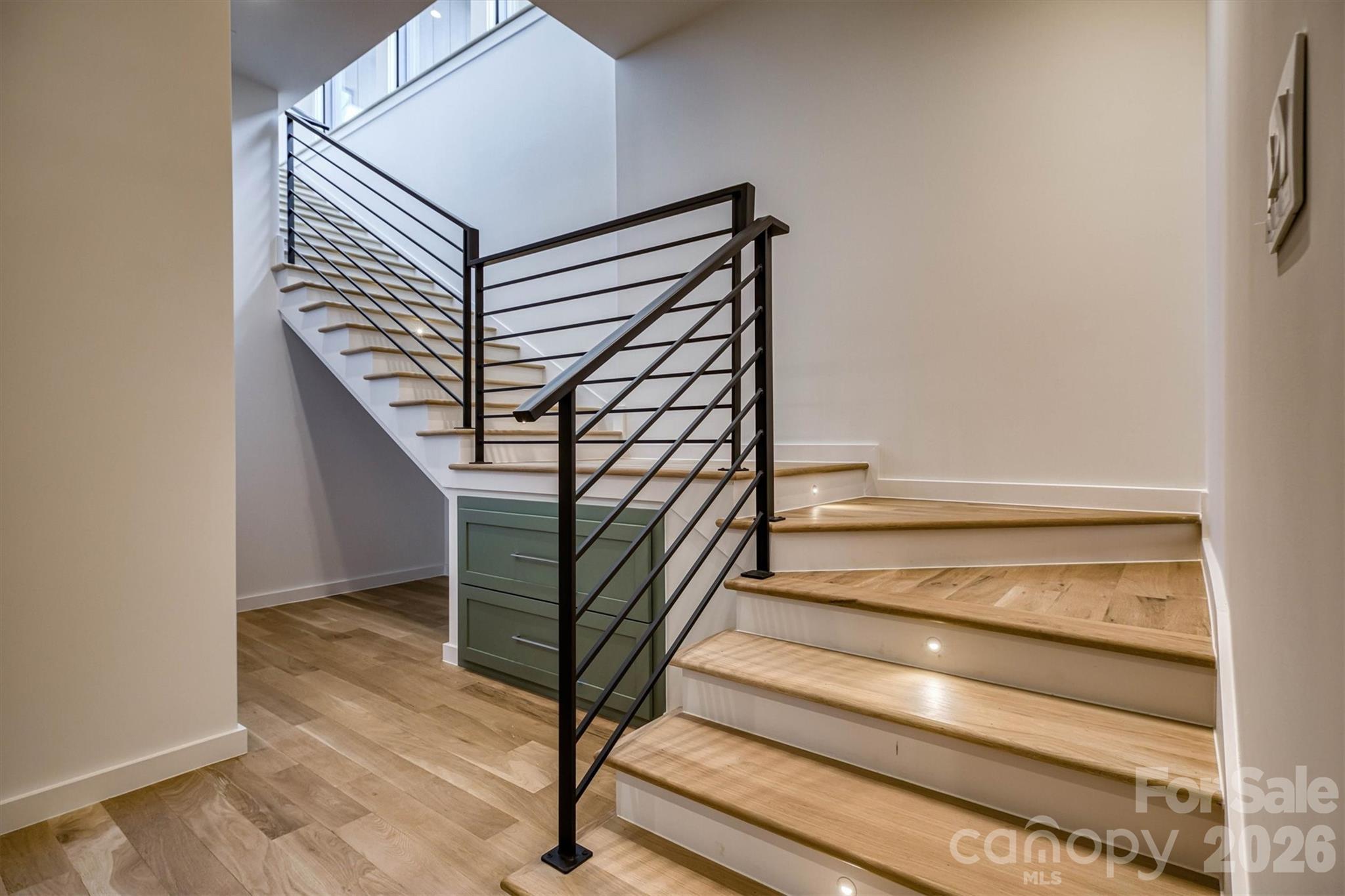 Custom metal railings and additional storage in stairwell - 463 Summit Trail, Nebo