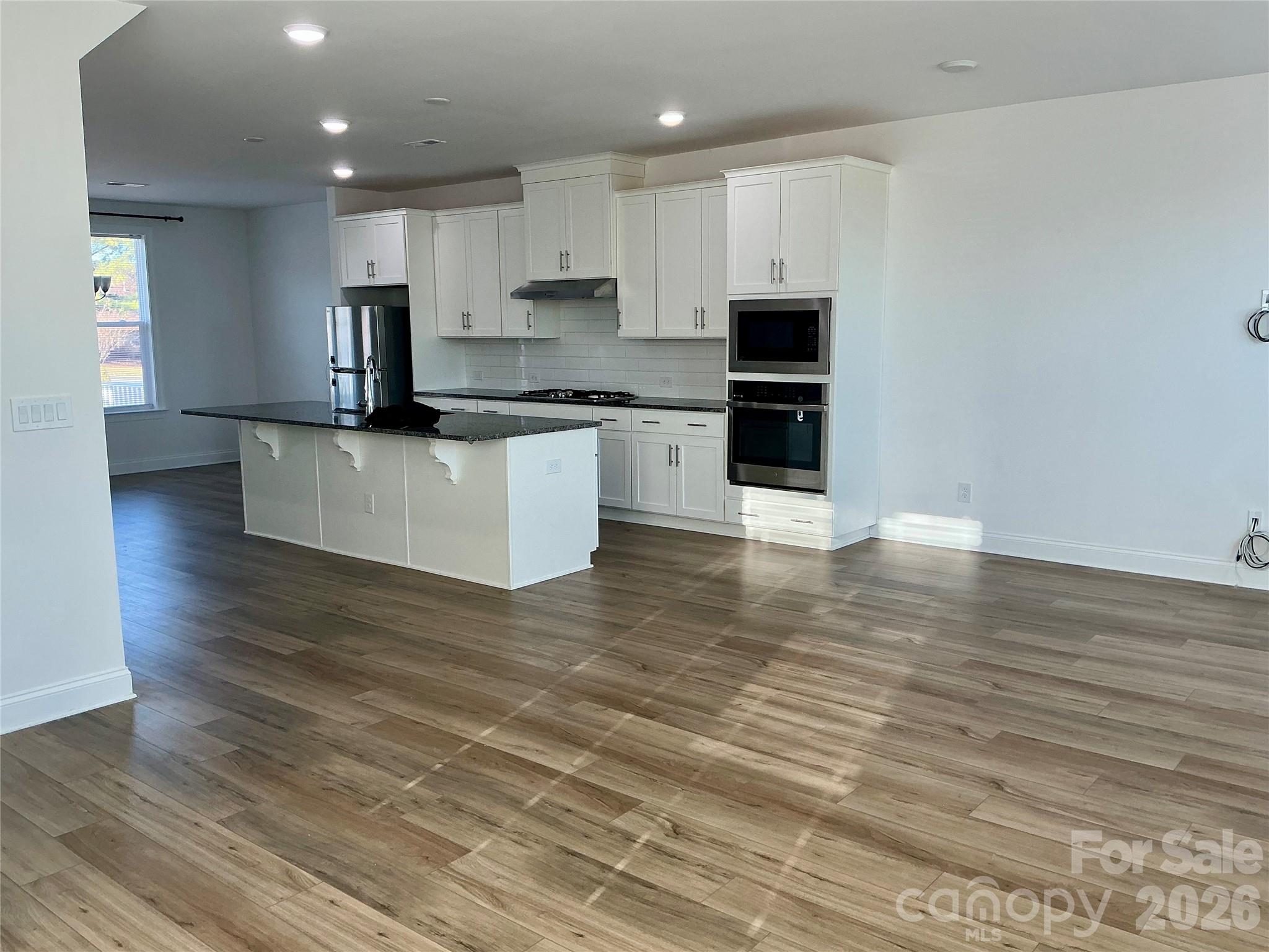 Beautiful flooring, quality cabinetry and granite countertops - 9240 Walnut Hill Road NW, Concord