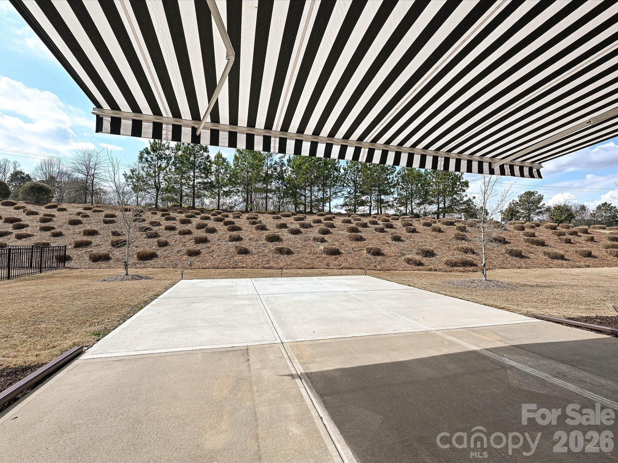 Rear Patio displaying the retractable awning - 2004 Rockbrook Lane, Belmont