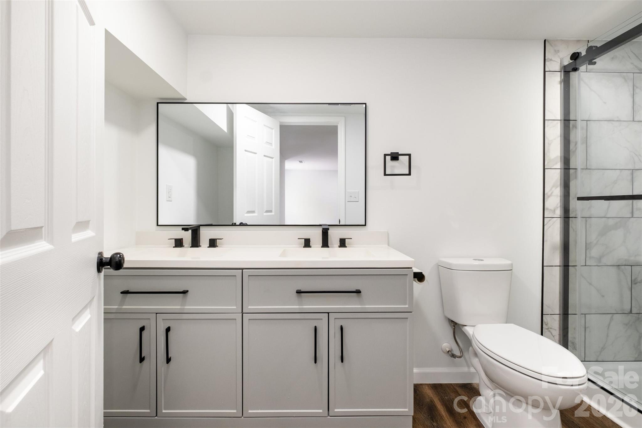 Lovely double vanity in primary bedroom with tiled shower - 503 Circle Drive E, Shelby