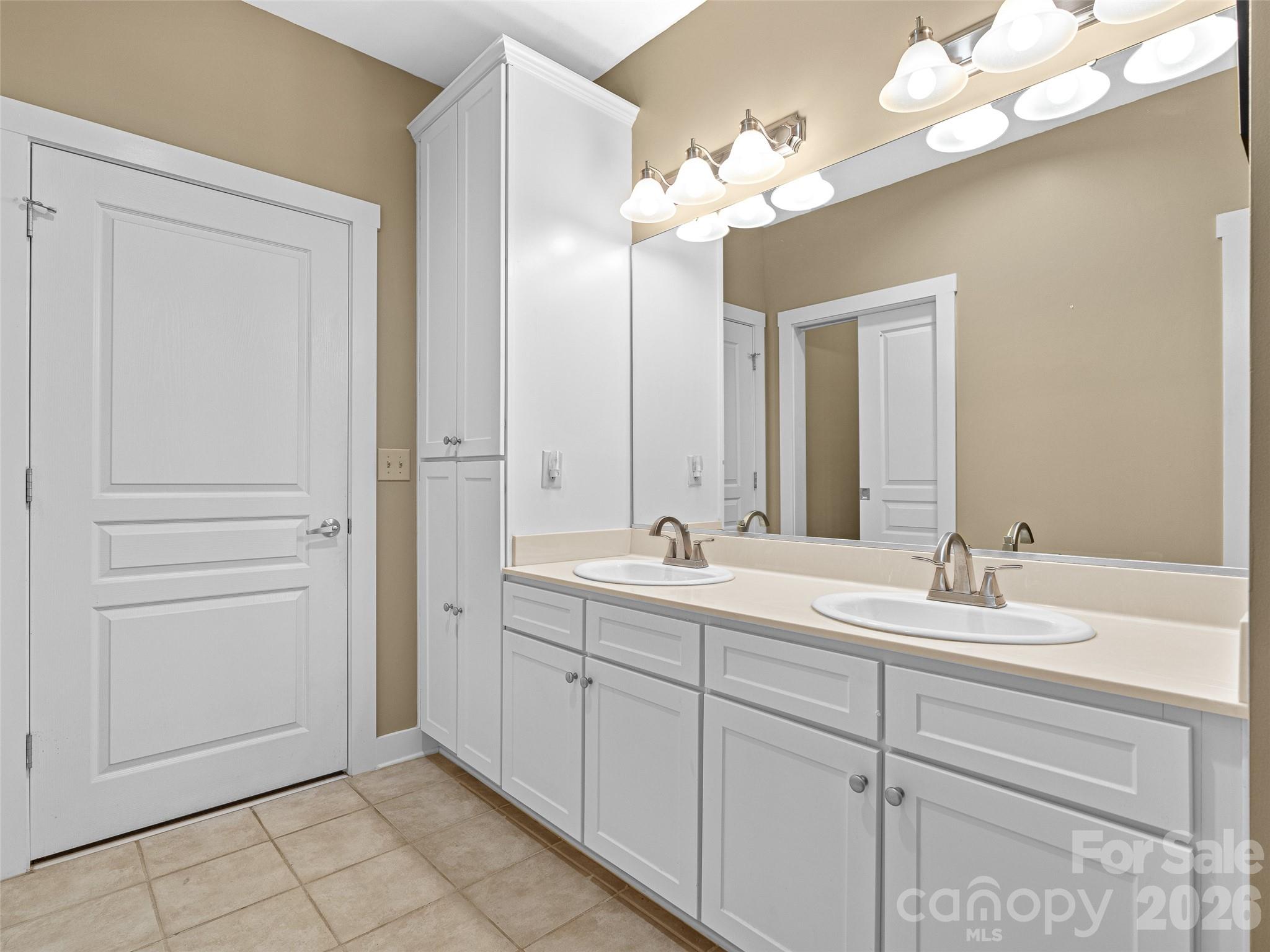 Primary bathroom double sink vanity with linen, the door is to the primary bedroom - 9 Kenilworth Knoll, Asheville