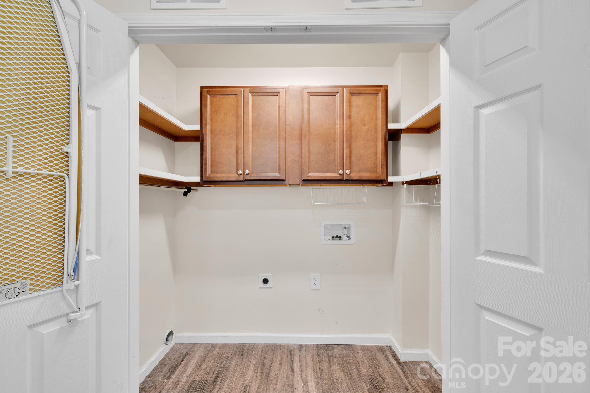 Laundry closet with custom shelving and cabinets. - 372 E Mills Avenue, Mooresville