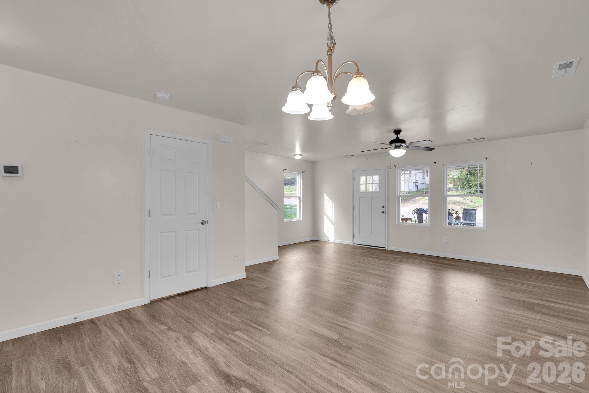 Open Dining and living area. Door is a custom closet for storage! - 372 E Mills Avenue, Mooresville
