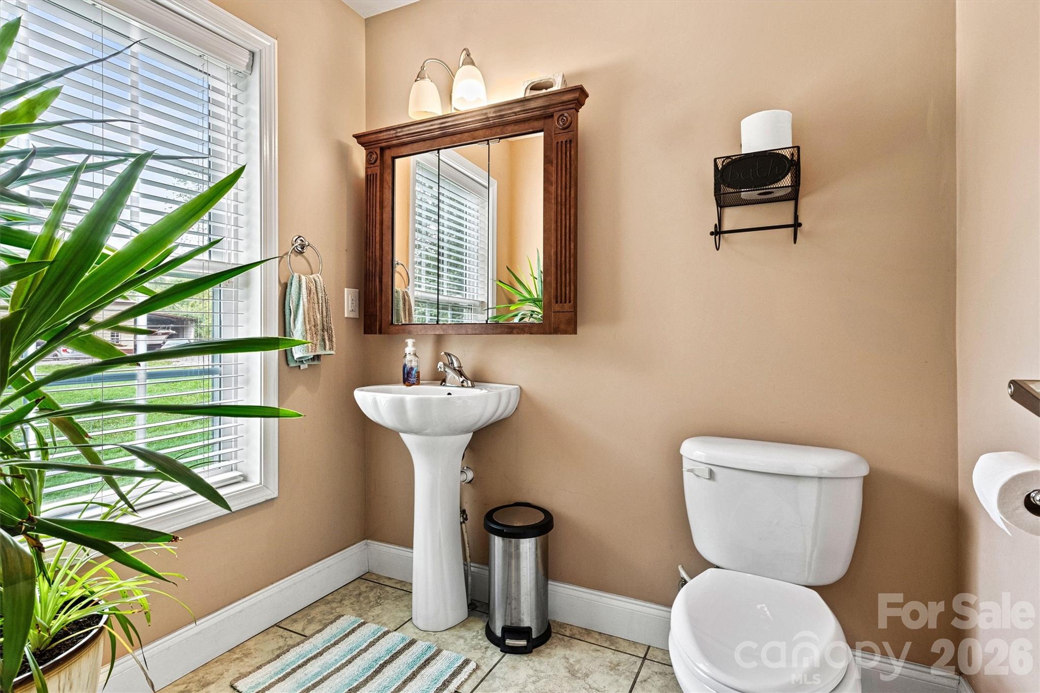 half bath ensuite, located in downstairs Primary suite - 6051 Pointe West Lane, Vale