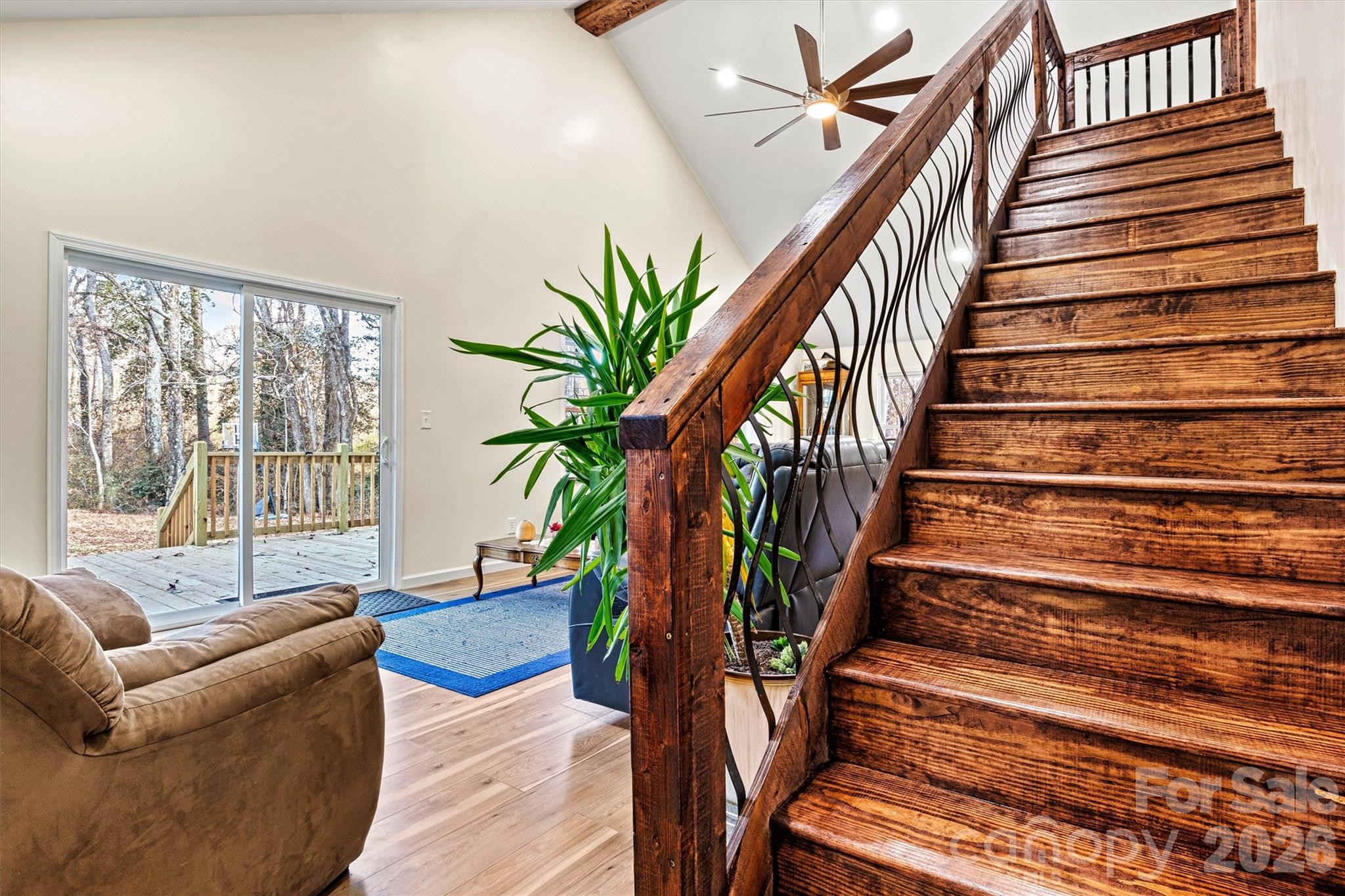 staircase to upstairs - showing of high ceilings in the living room - 6051 Pointe West Lane, Vale