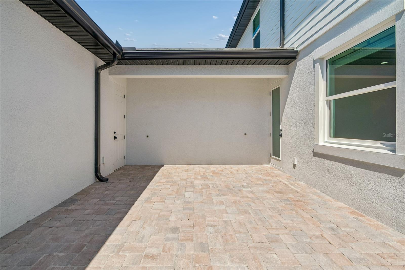 Courtyard-Photo description represents the model home of same floor plan. - 17736 BROADLEAF LOOP, VENICE
