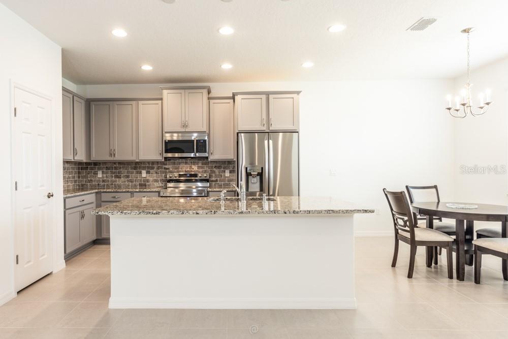 Kitchen area open to living room - 10 FISCHER LN, PALM COAST