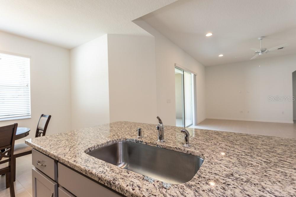 Kitchen island with granite countertop - 10 FISCHER LN, PALM COAST
