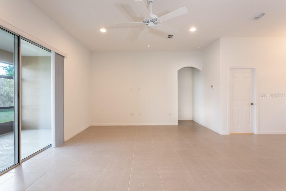 Living room with glass sliders to rear porch - 10 FISCHER LN, PALM COAST