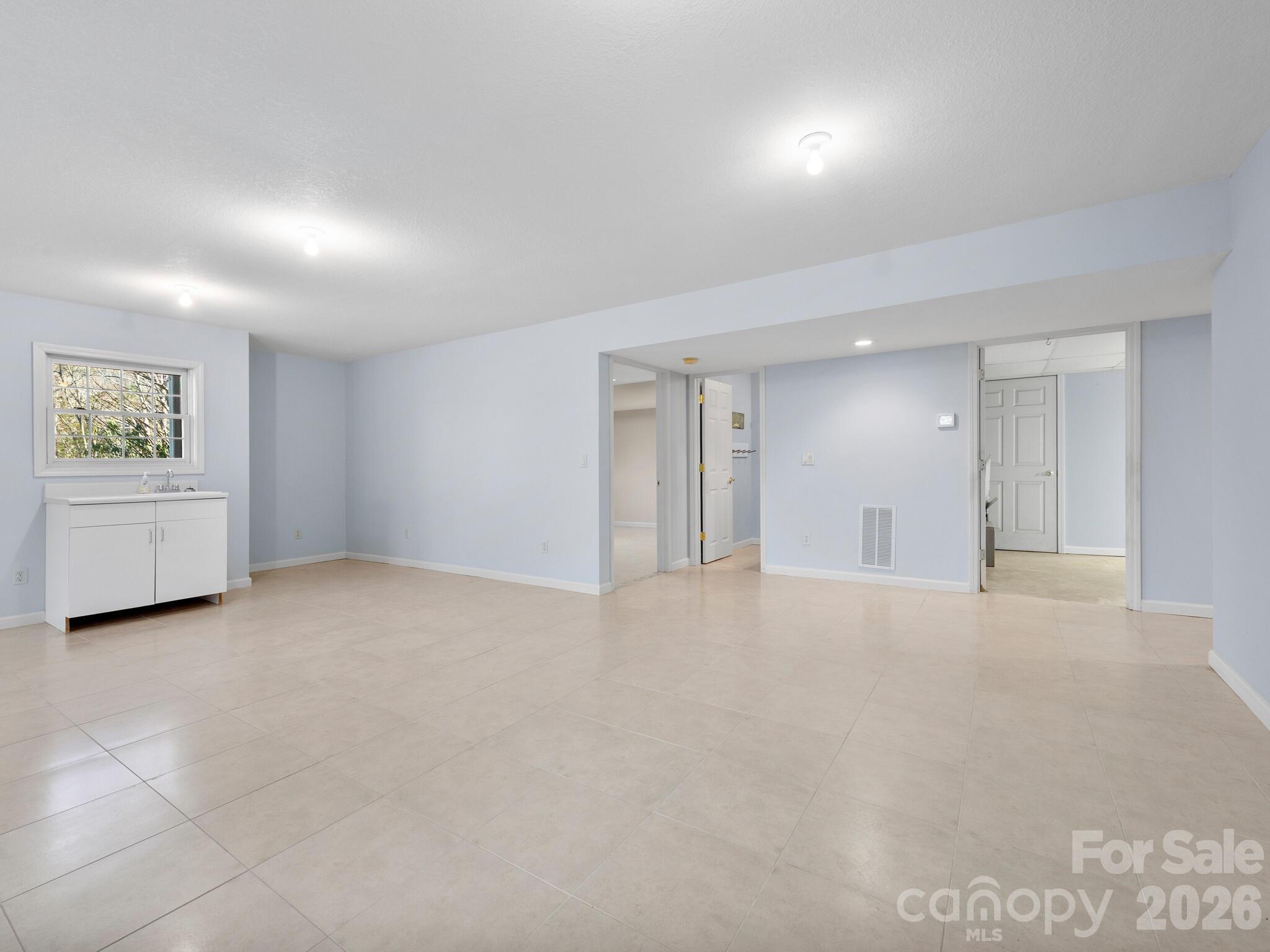 Lower Level Living Room Plumbed for Kitchenette - 17 Ashton Forest Court, Hendersonville