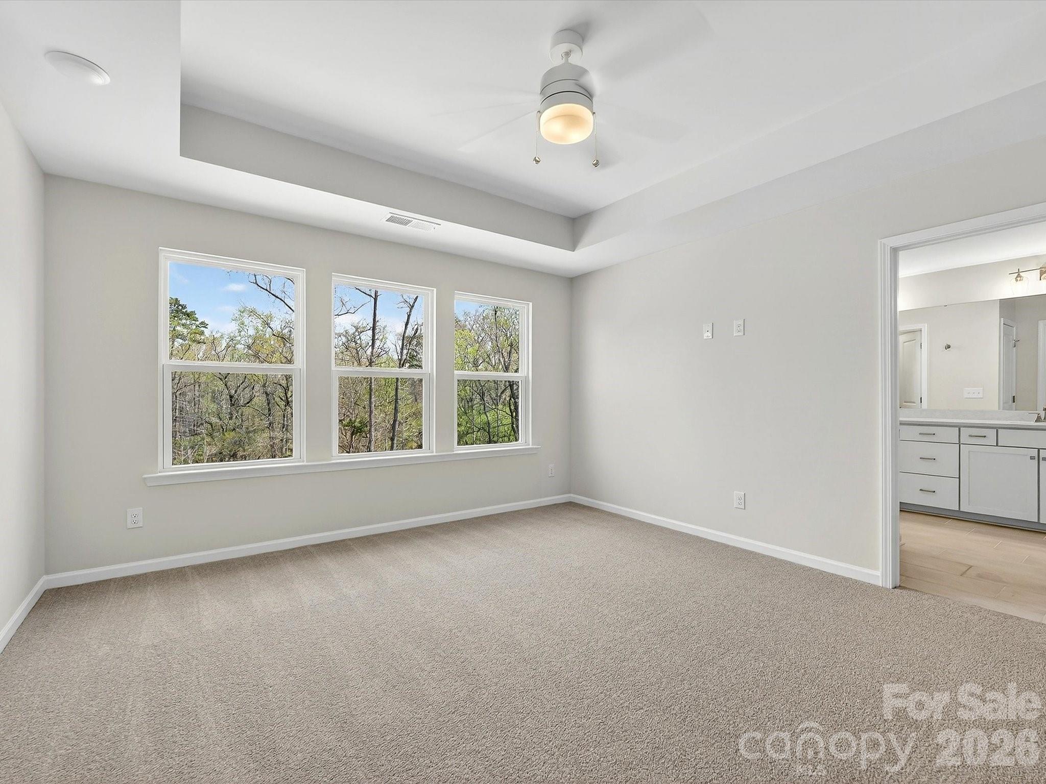 Primary bedroom with views of the nature preserve - 258 Alluvium Lane, Waxhaw
