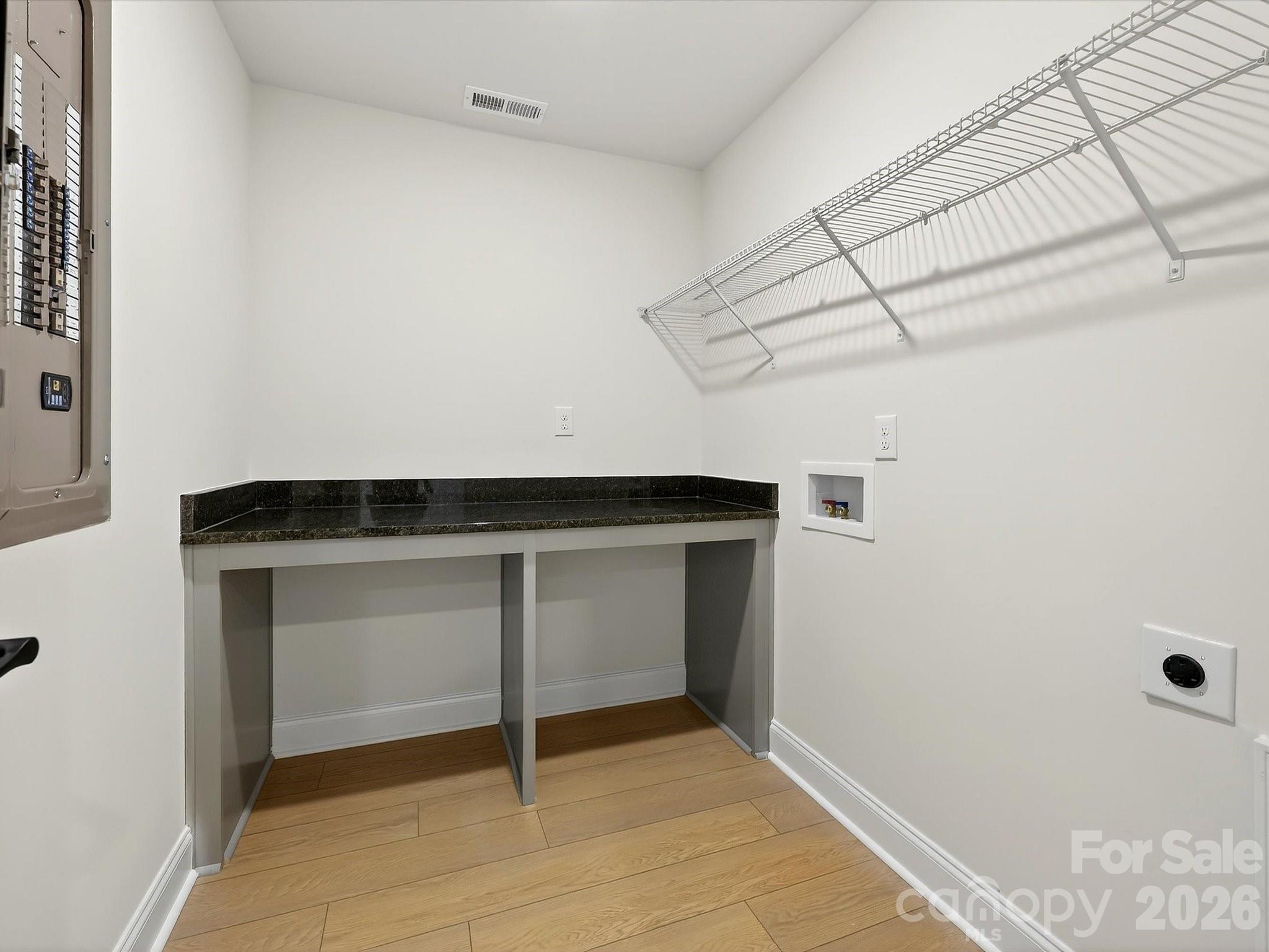Laundry room with folding table - 218 Quartz Hill Way, Waxhaw