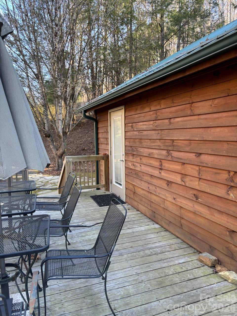 Main house side deck. Come out through the French doors and listen to the water flowing down the creek - 324 Marble Mine Road, Bakersville