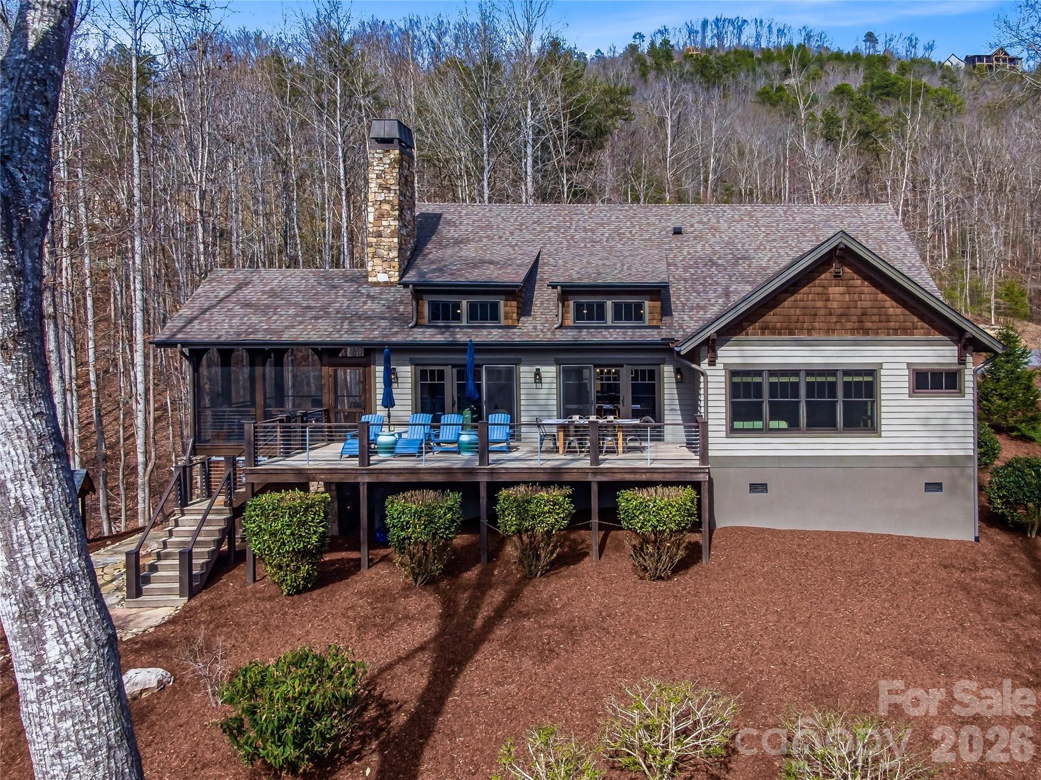 Rear of the home showing the screened porch and deck. - 3735 French Broad Parkway, Marshall