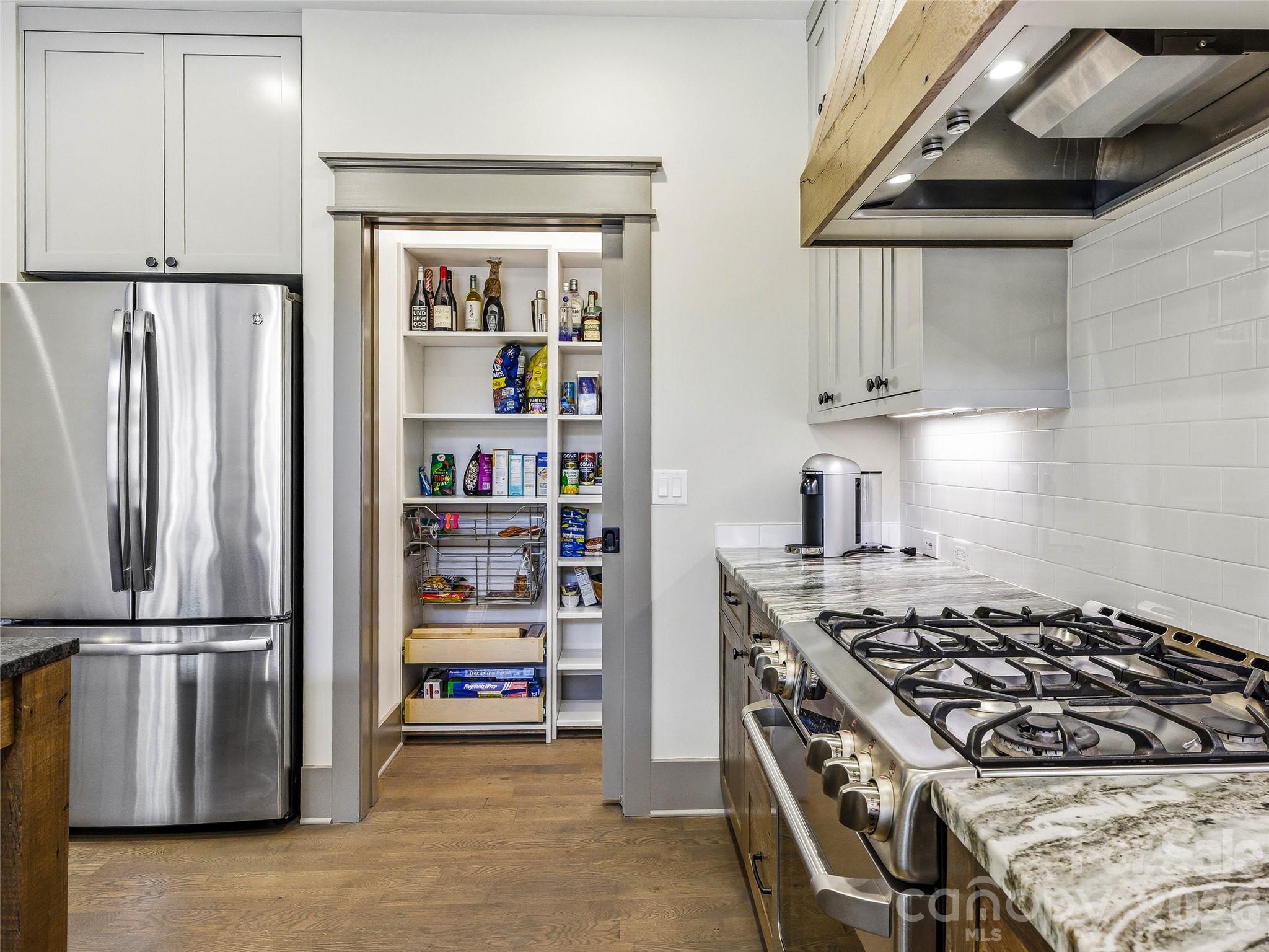 Large walk-in pantry which extends to the right. The microwave is stowed away in this area. - 3735 French Broad Parkway, Marshall