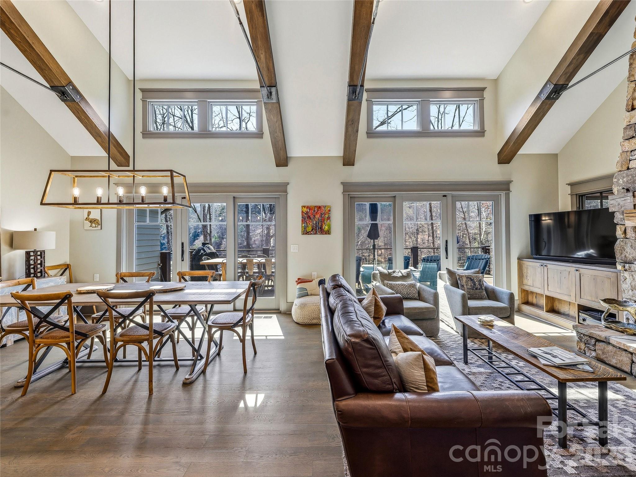 Open concept living with wood and stone features adding warmth and character. - 3735 French Broad Parkway, Marshall