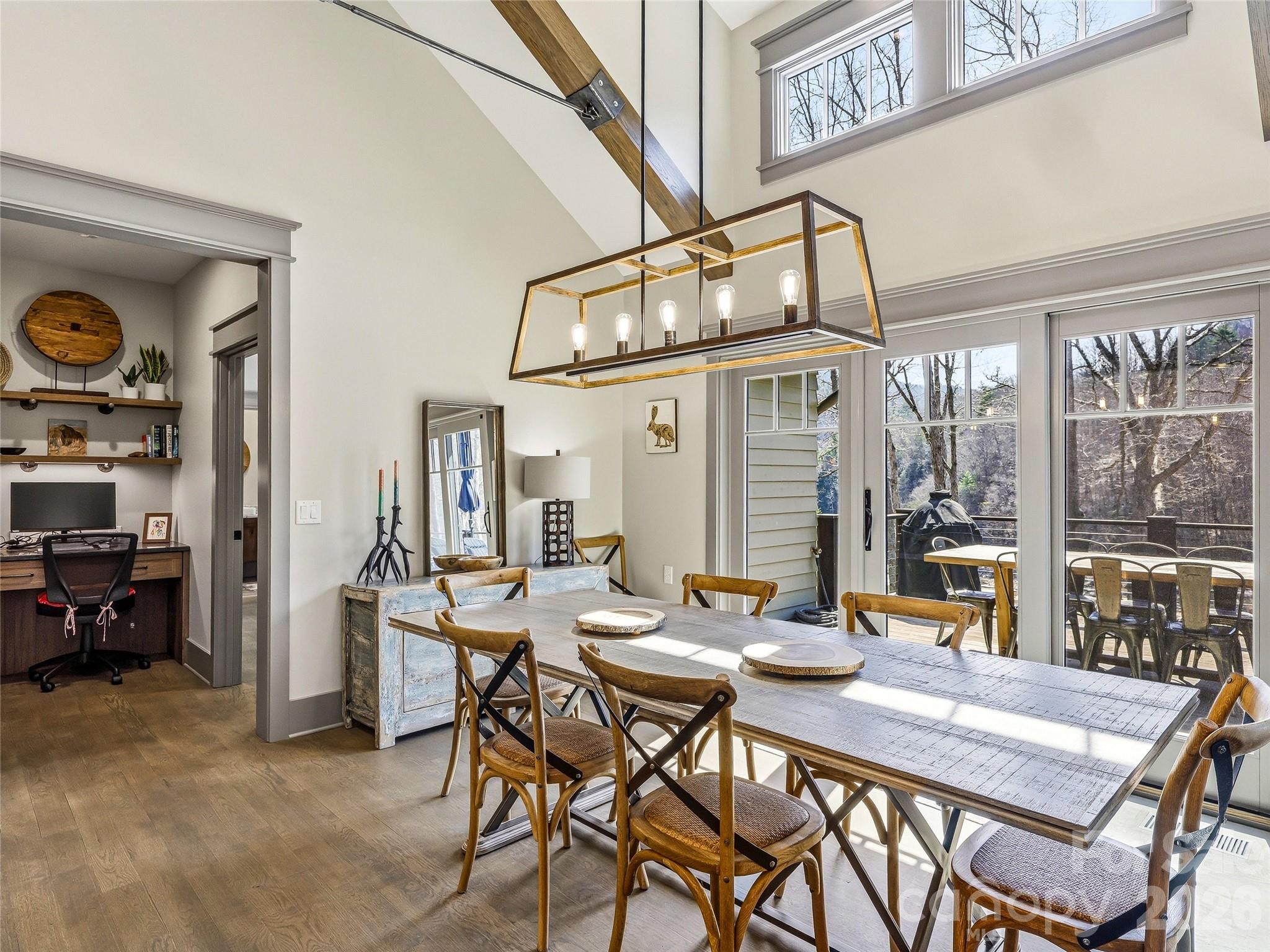 Dining area with access to the rear deck. Built-in desk in the hall. - 3735 French Broad Parkway, Marshall