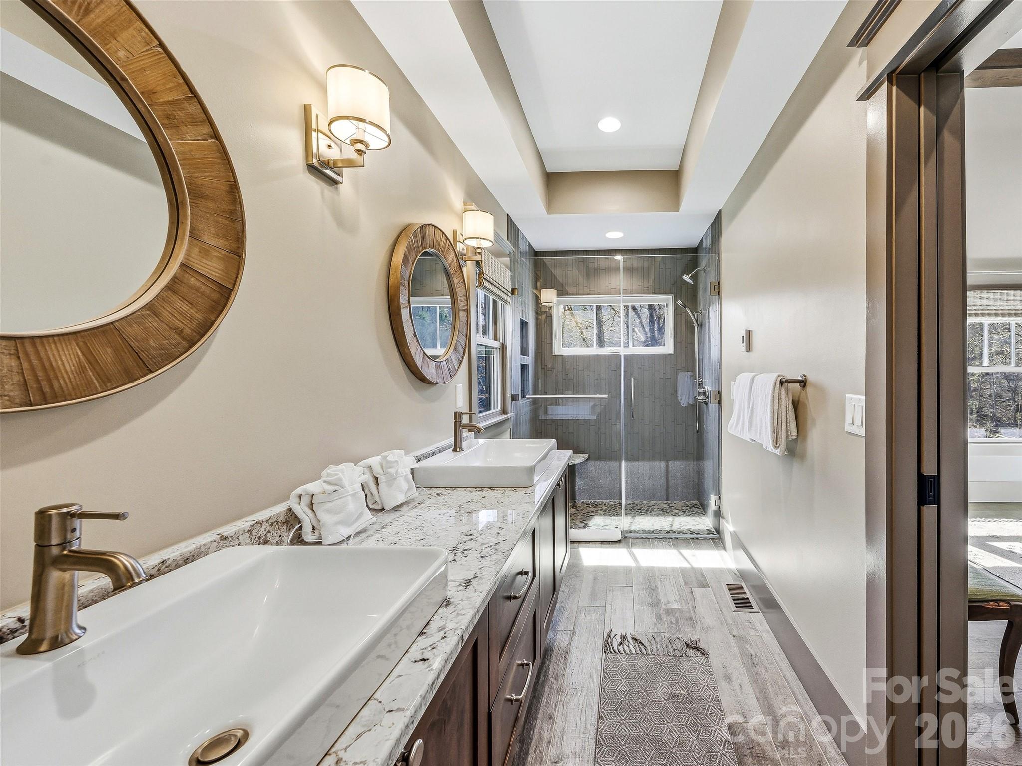 Primary bath with dual vanities and large walk-in shower. - 3735 French Broad Parkway, Marshall