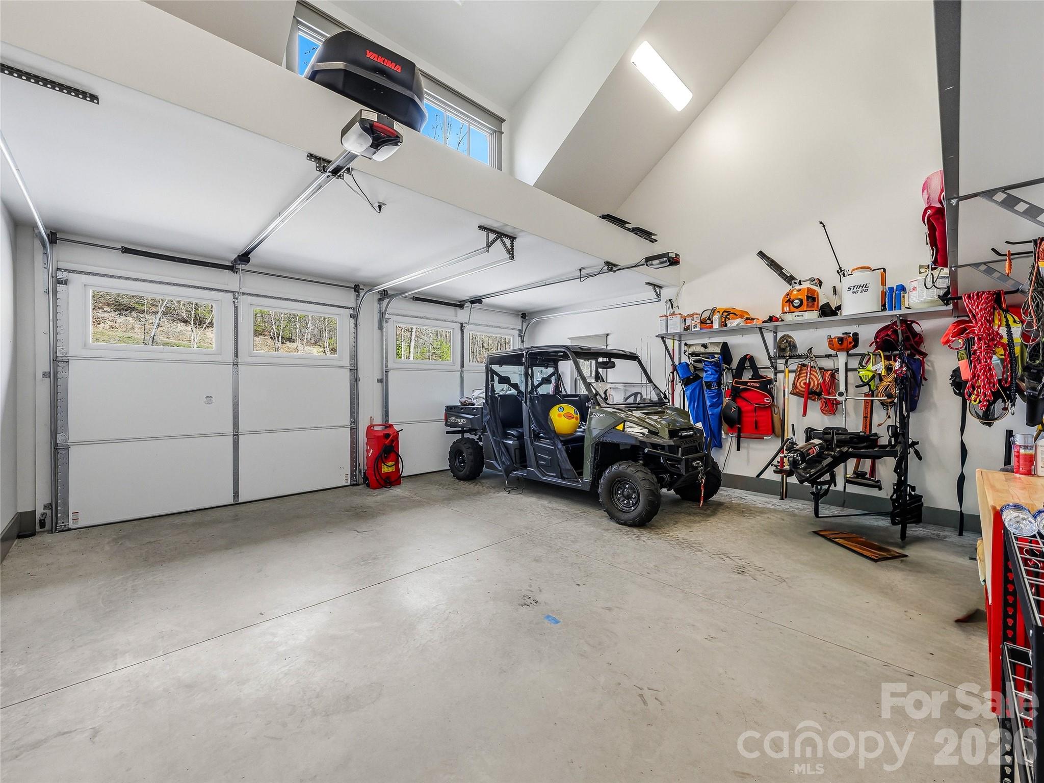 Upper storage area in garage. Insulated garage doors. - 3735 French Broad Parkway, Marshall