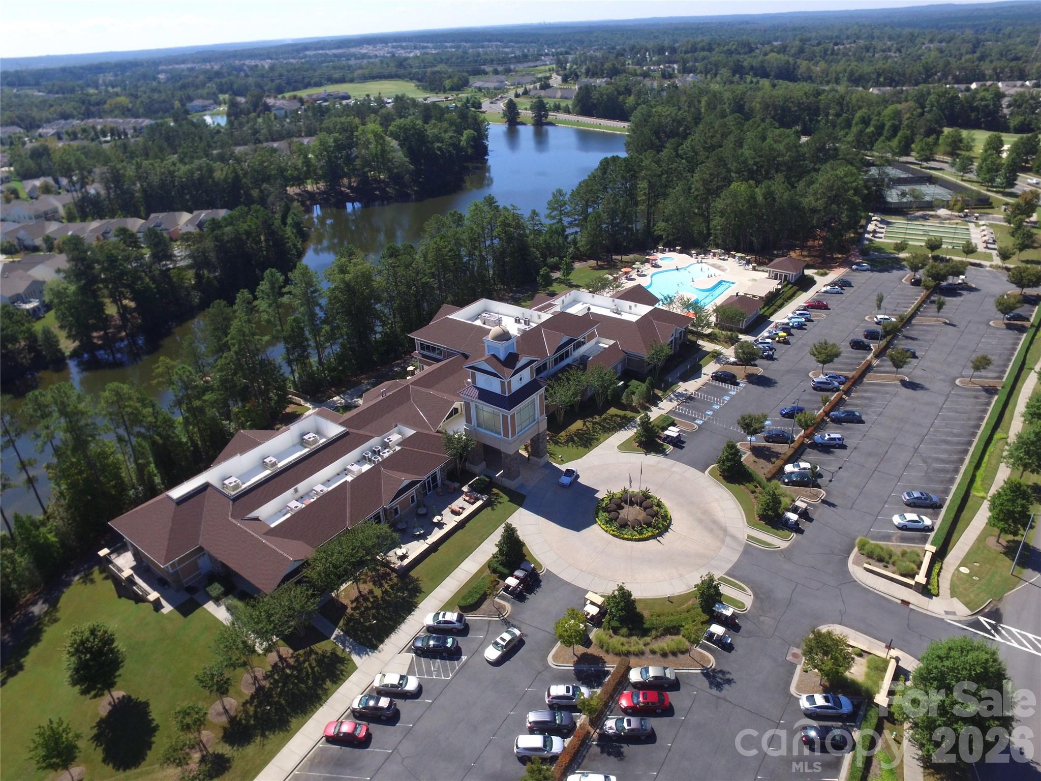The Lake House is the main hub of the community and boasts a beautiful lobby with fireplace and view of the lake, 2-story state-of-the-art fitness center, billiards, cards, table tennis areas, card & meeting rooms, large ballroom for social events and other community activities, a covered event pavilion, a fabulous pottery studio, shuffleboard courts, and indoor and outdoor swimming pools. - 49015 Gladiolus Street, Indian Land
