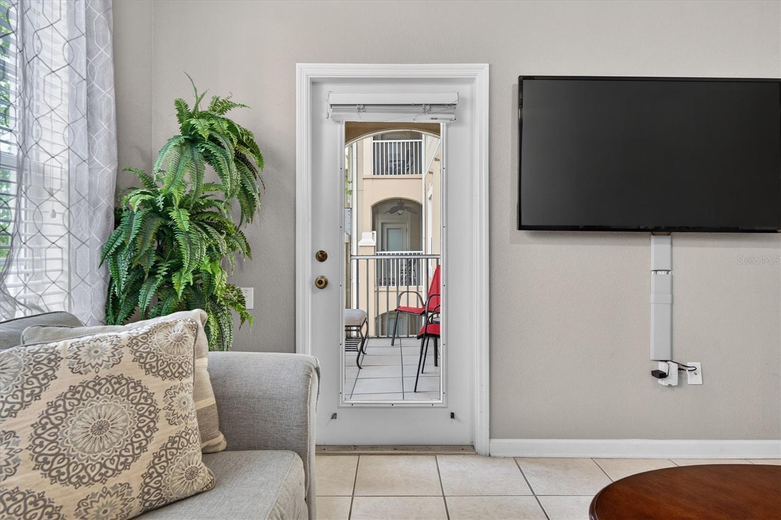 Living Room & Balcony View - 7664 COMROW ST #304, KISSIMMEE