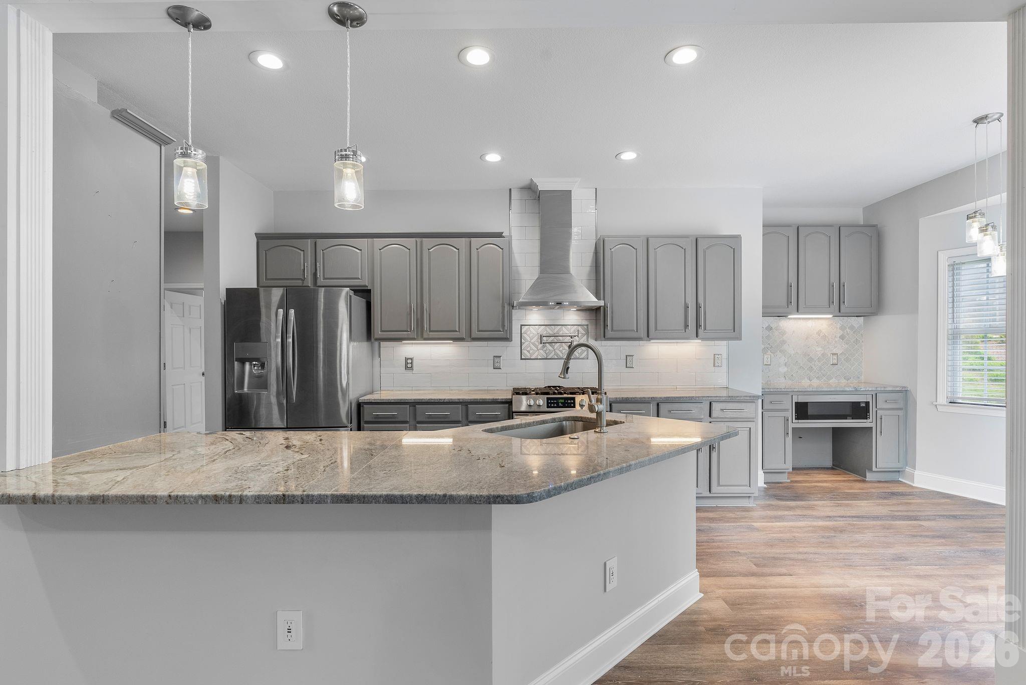Open kitchen for ease and entertainment opens to the sunset with large cable decking for family, friends and entertainment. - 79 Mill Pond Way, Hendersonville