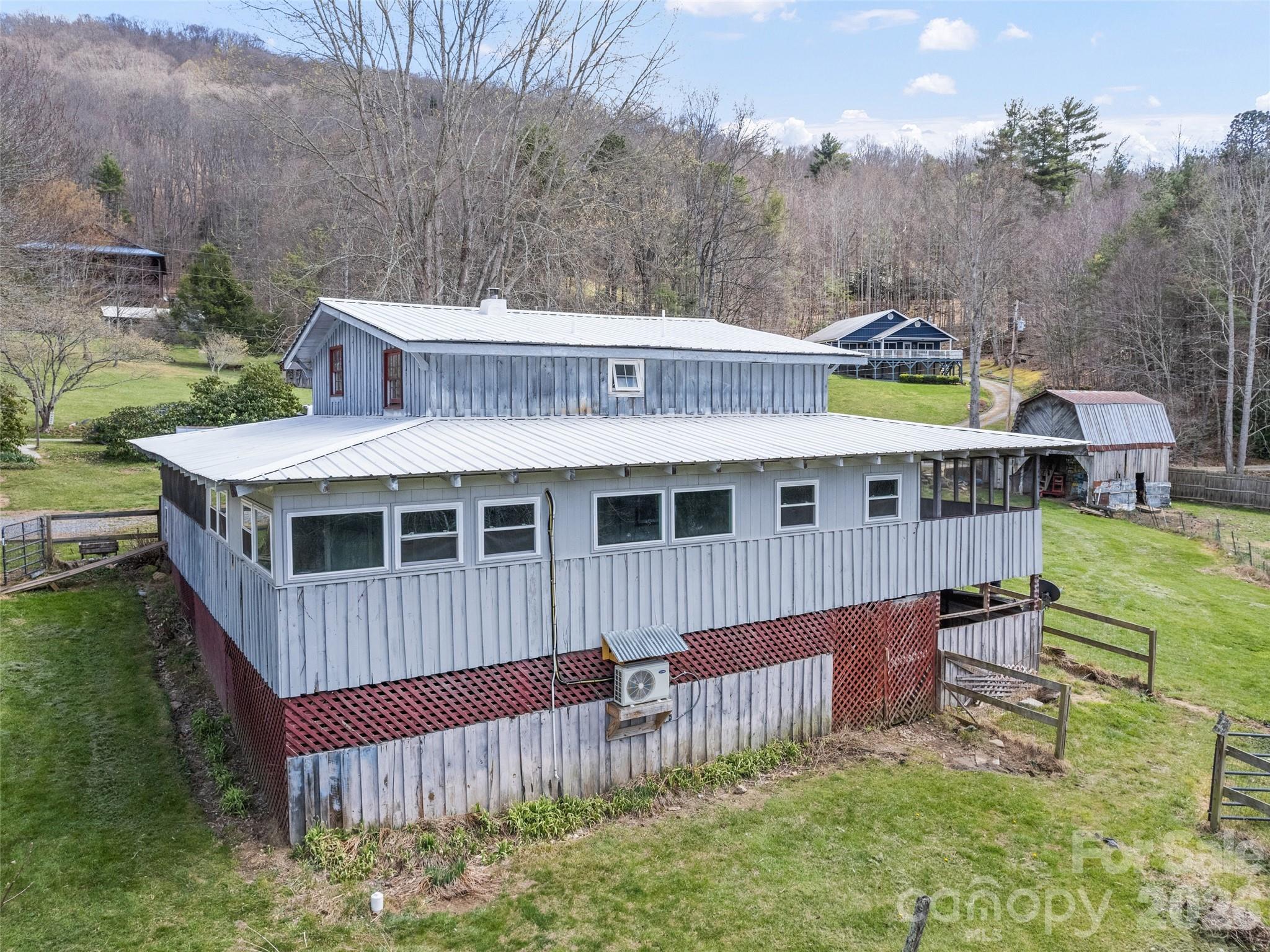 View of backside of house with basement entrance on right - 838 Hidden Valley Road, Clyde