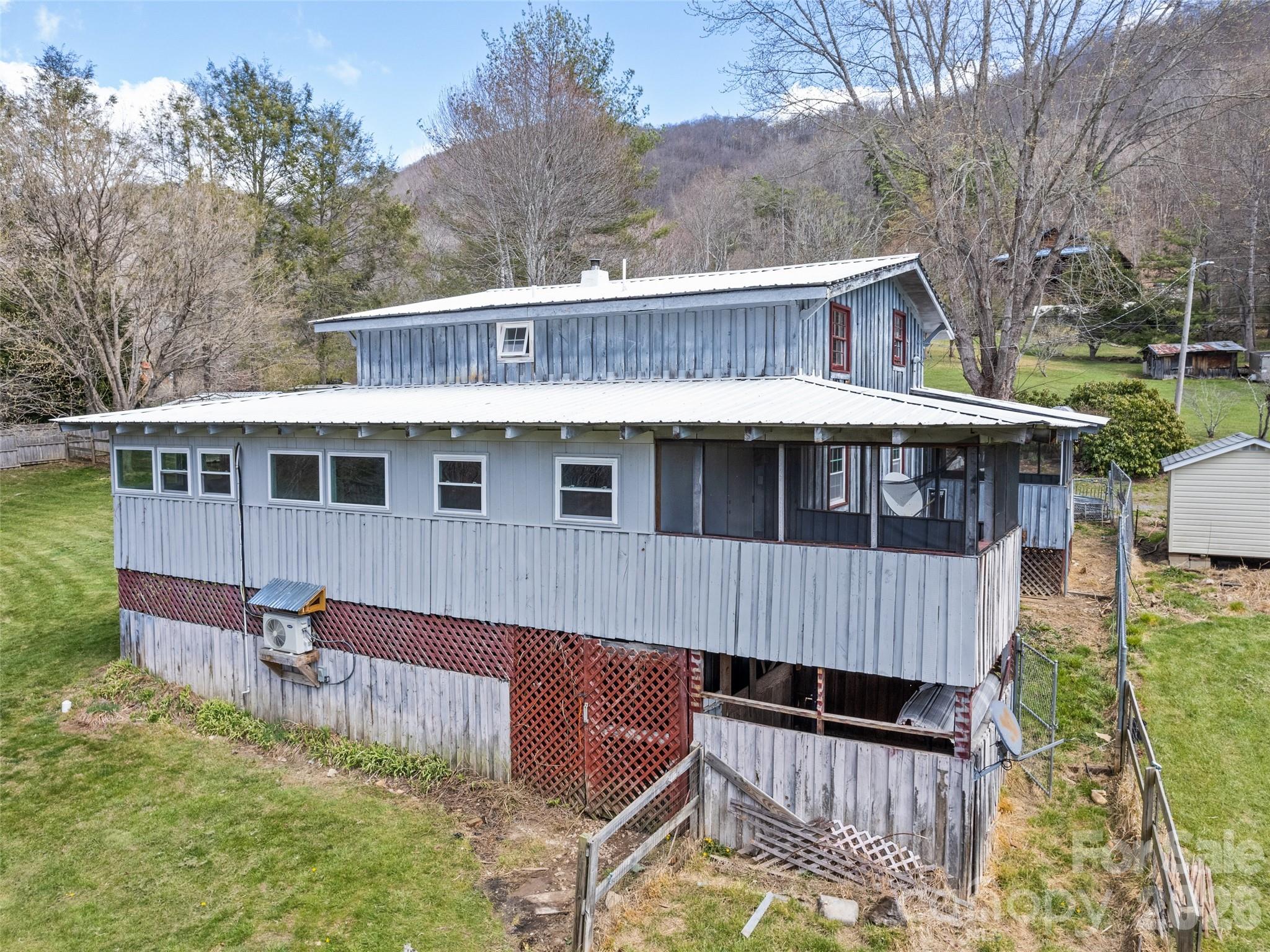 View of backside of house with basement entrance - 838 Hidden Valley Road, Clyde