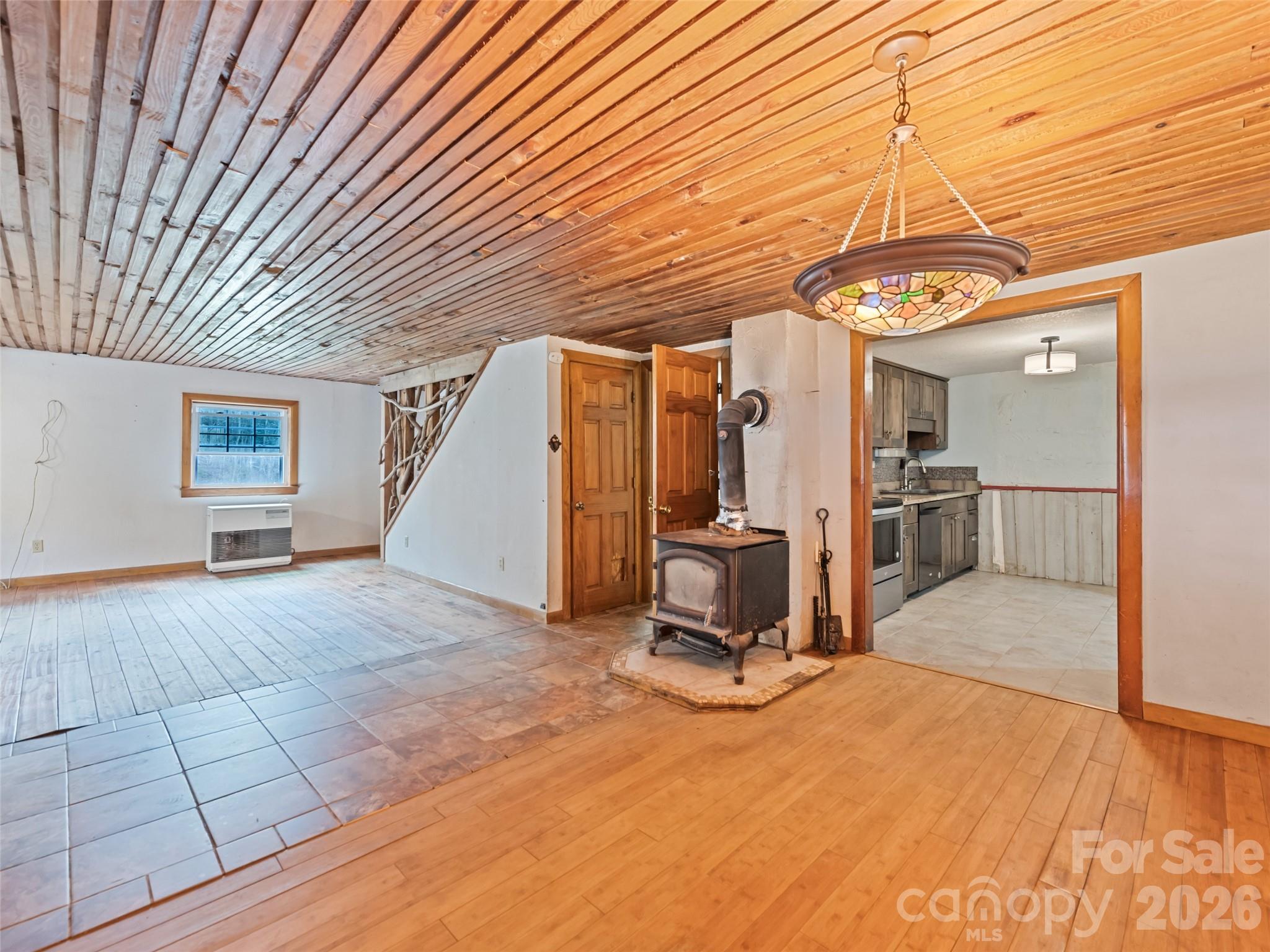 Open living area with wood ceilings and come wood stove - 838 Hidden Valley Road, Clyde