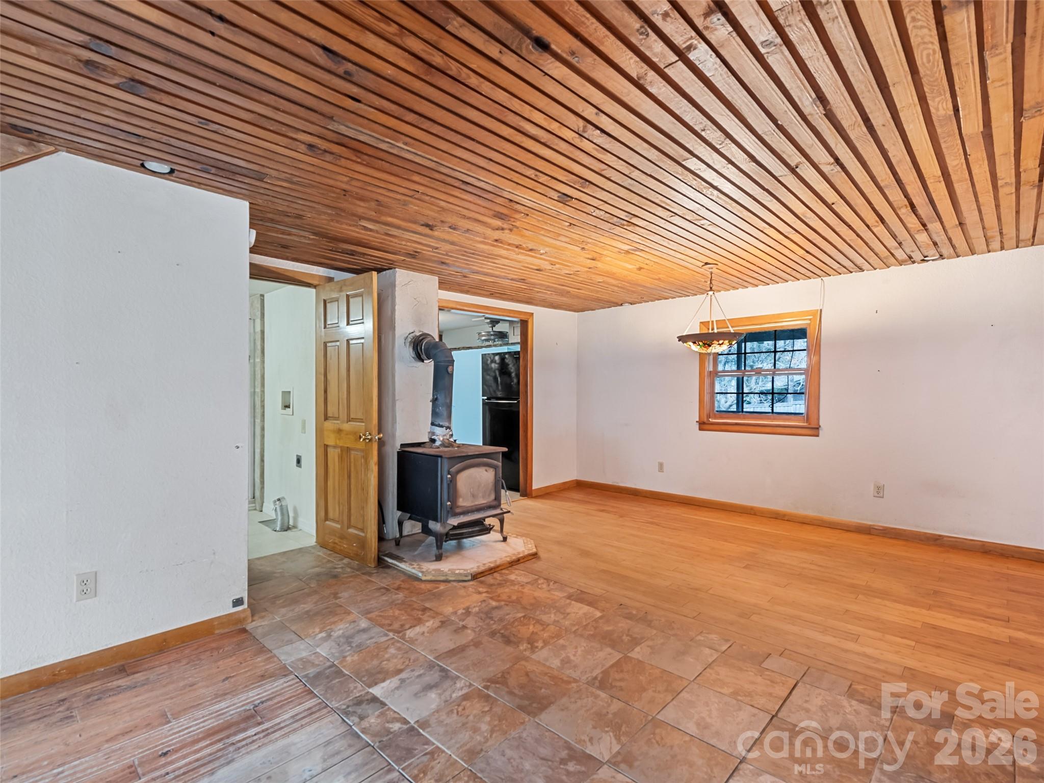 Open living area with wood stove - 838 Hidden Valley Road, Clyde