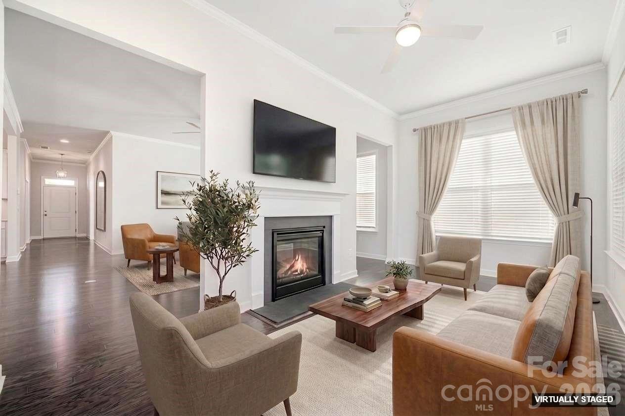 Virtually staged sunroom and two-sided fireplace. - 456 Lucky Drive NW, Concord