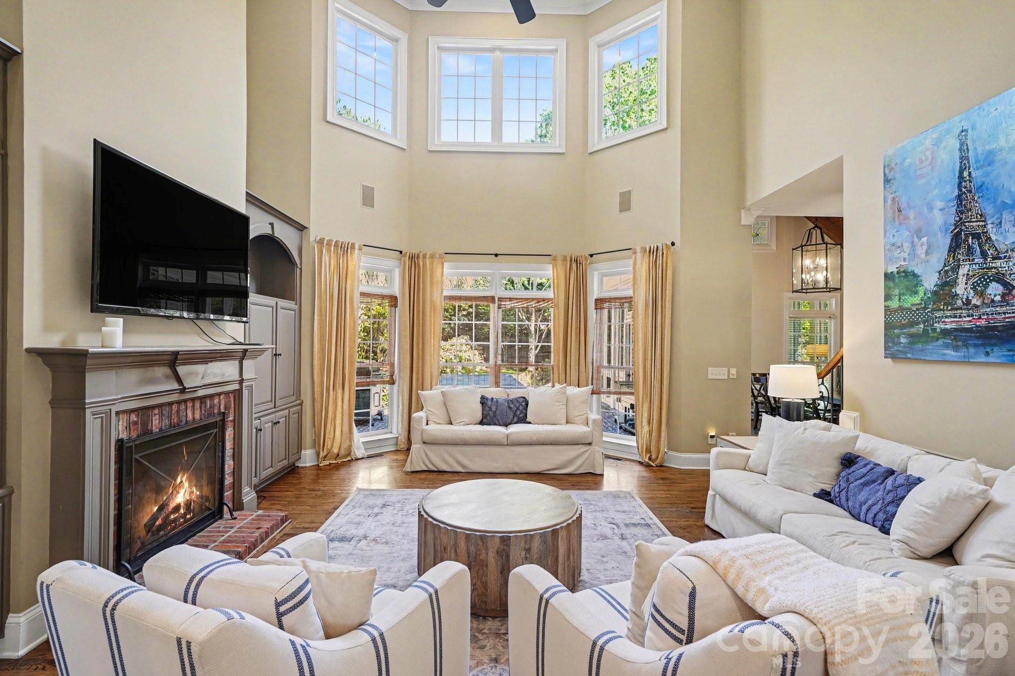 Large 2-story family room with Large windows and Built-ins - 7609 Windaliere Drive, Cornelius