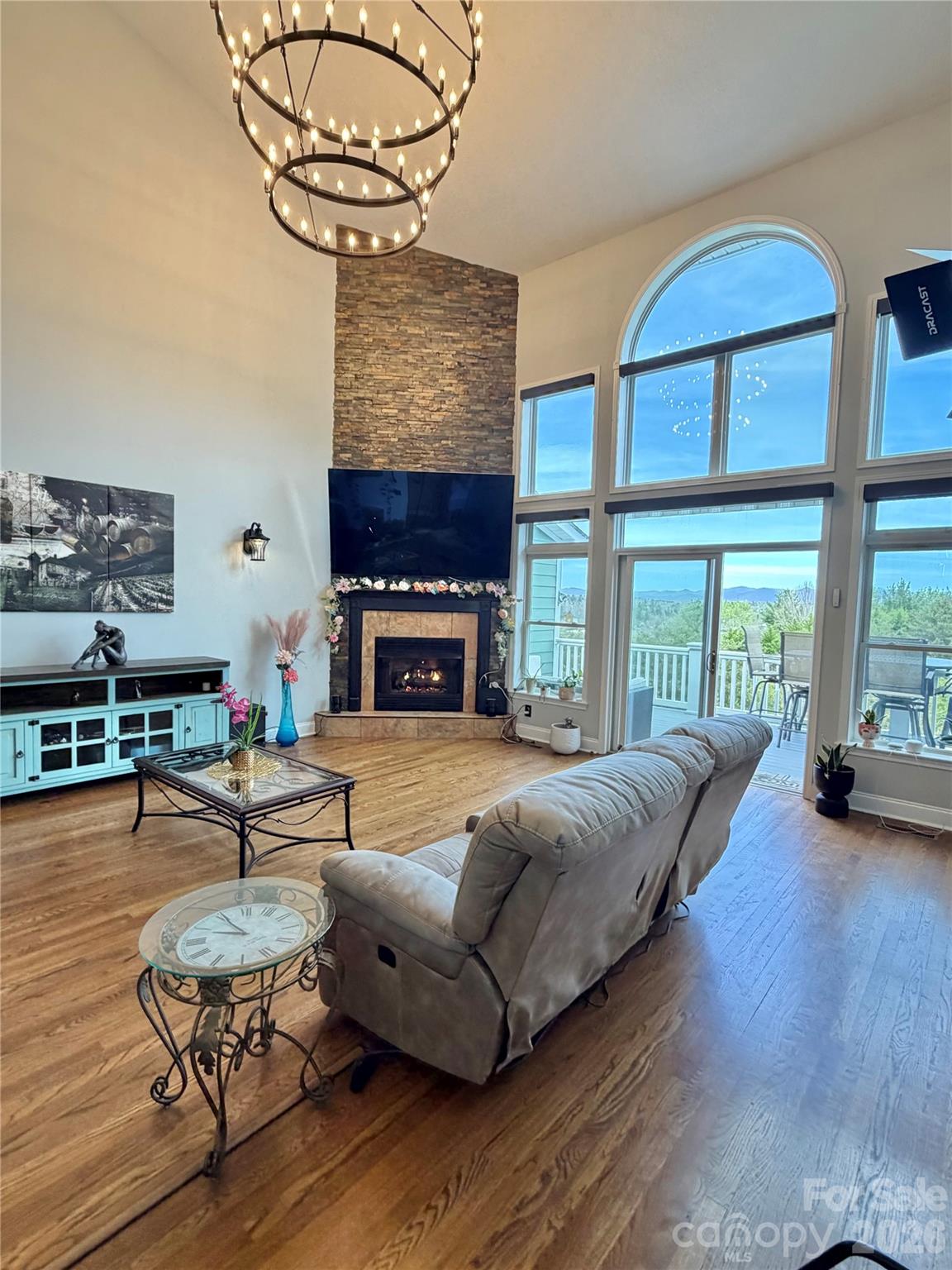 living room with spiral chandelier overhead - 5 Gemini Heights, Weaverville