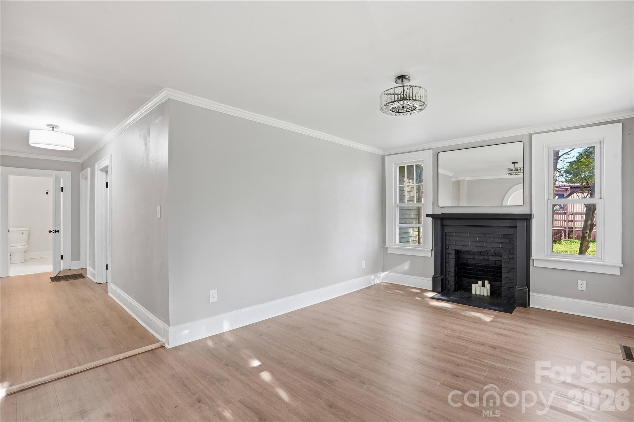 Inviting living room centered around a charming fireplace - 234 S Ervin Avenue, Newton