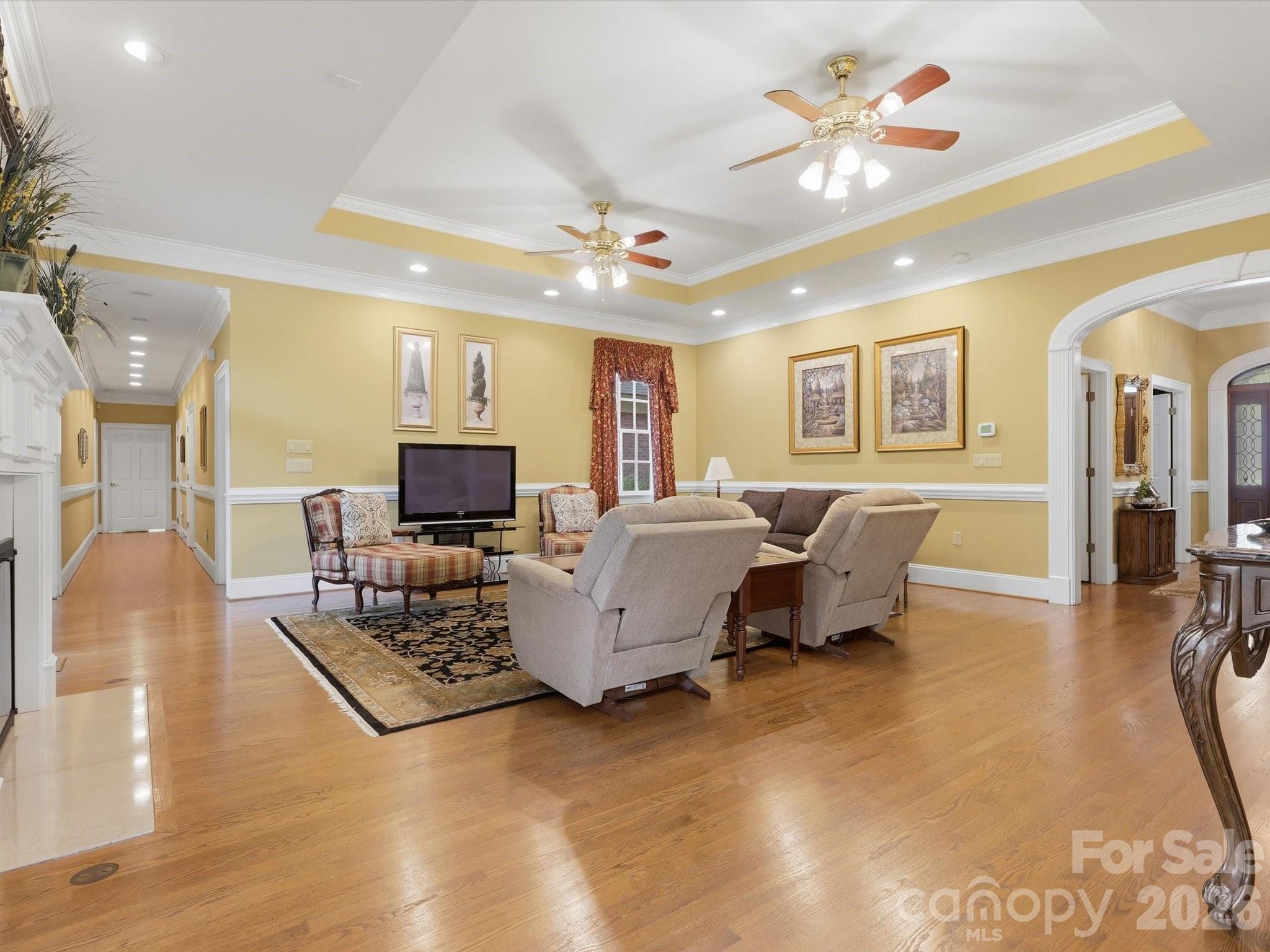 Family room/ Den. Hallway to bedrooms and garages. Trey ceiling, arched doorways. Pristine hardwoods. Electrical outlets in floors. - 1215 Rosa Drive, Monroe