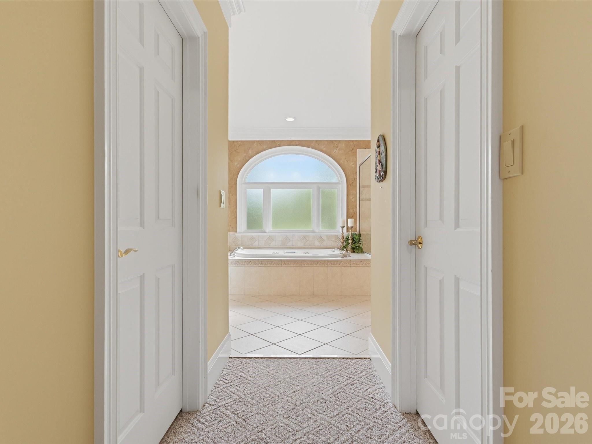 primary bed to bath hallway with two spacious walk in closets - 1215 Rosa Drive, Monroe