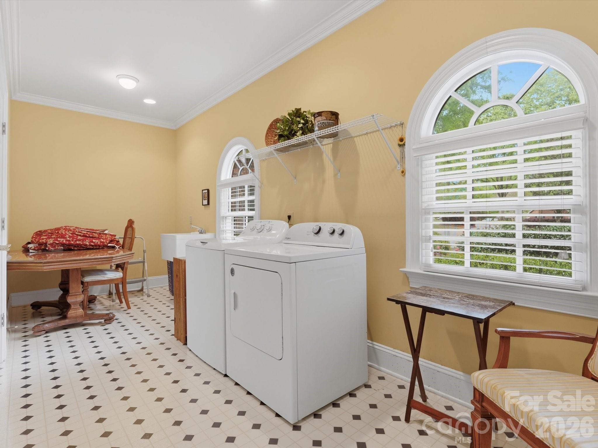 Laundry room with sink and closet storage. - 1215 Rosa Drive, Monroe