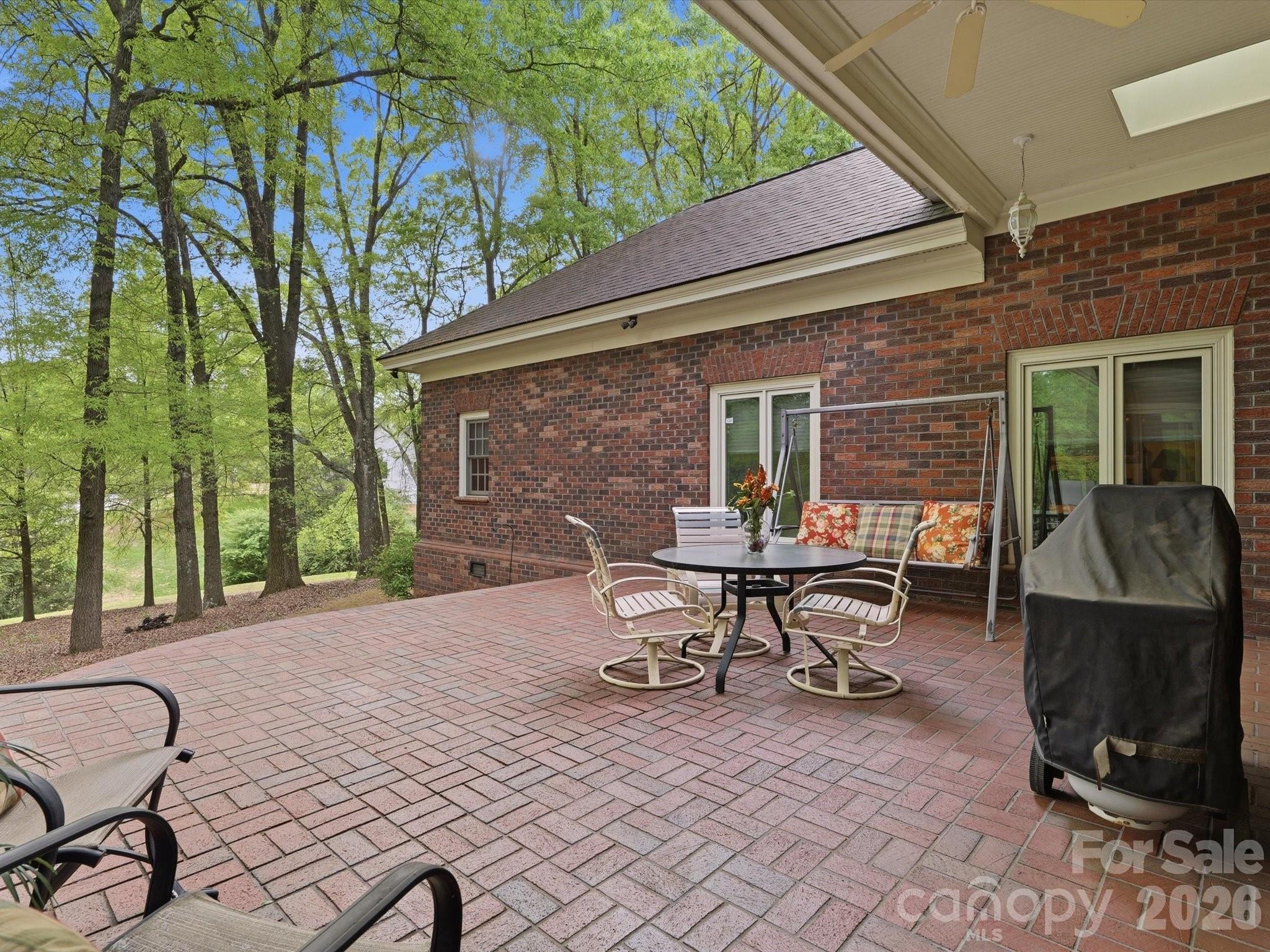 Brick patio with curved/ rounded stairways (keeping with the arched, curved theme). Views of lake. Partially covered area. - 1215 Rosa Drive, Monroe