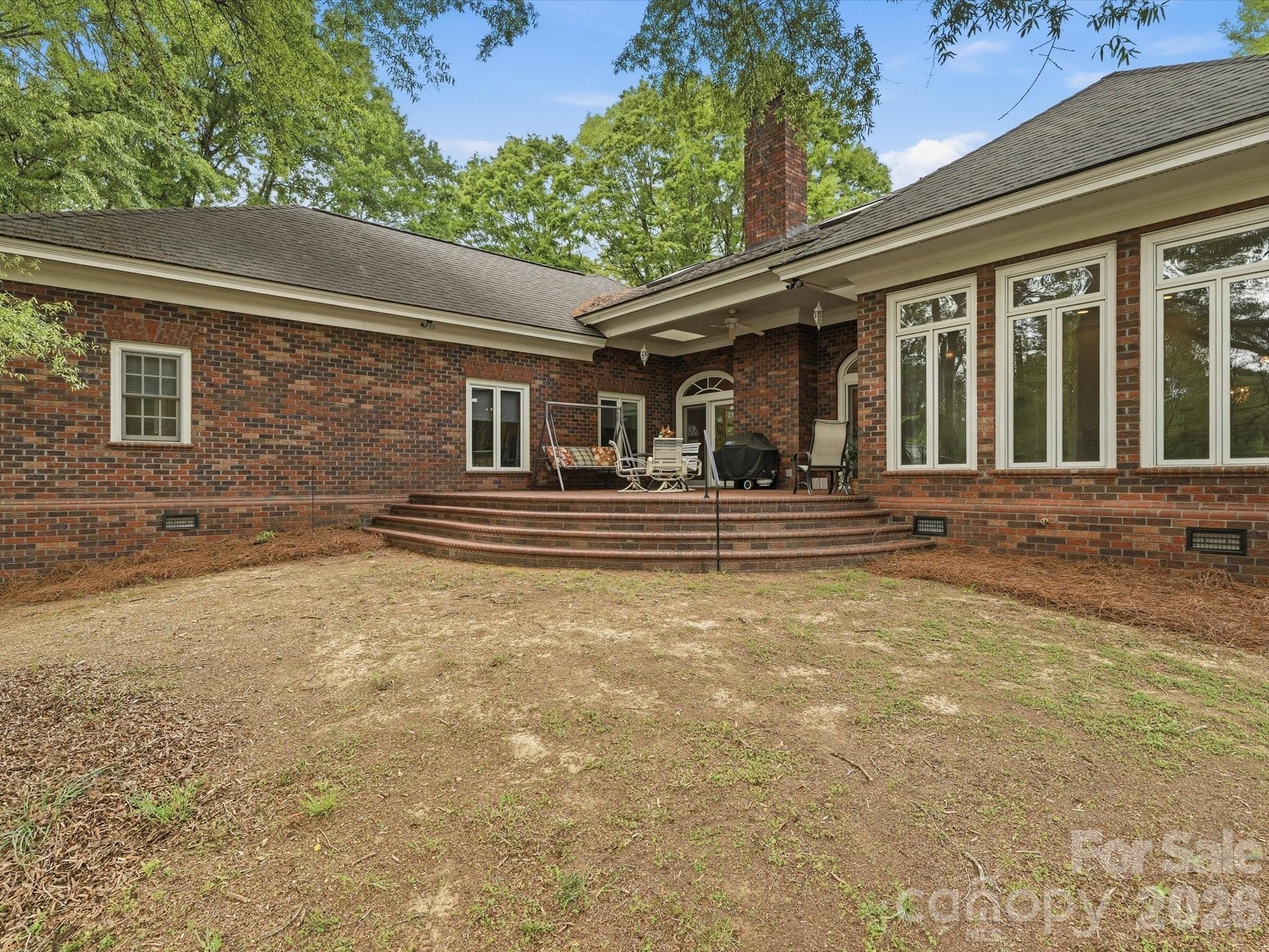 curved brick patio facing lake - 1215 Rosa Drive, Monroe