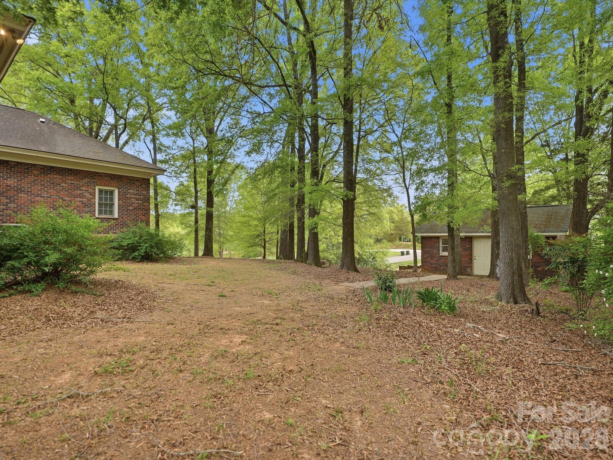 Right side of house with additional detached garage/storage building - 1215 Rosa Drive, Monroe