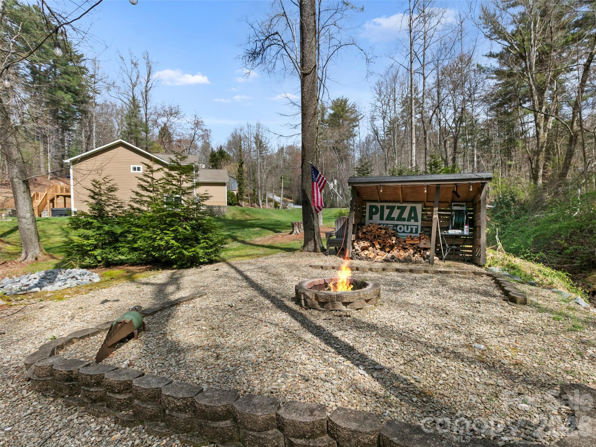 Inviting fire pit retreat nestled among the trees—perfect for cool mountain evenings and relaxed outdoor gatherings - 290 Sweetwater Hills Drive, Hendersonville