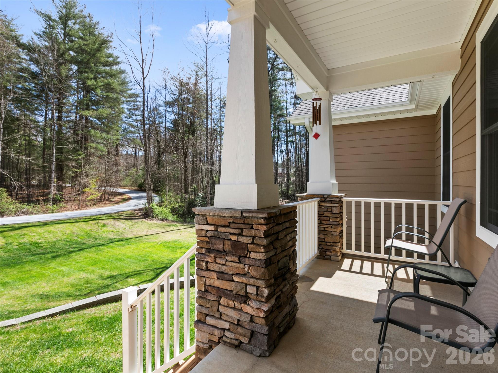 Inviting front porch offering a peaceful setting to relax and enjoy the quiet sounds of nature and the surrounding wooded landscape - 290 Sweetwater Hills Drive, Hendersonville