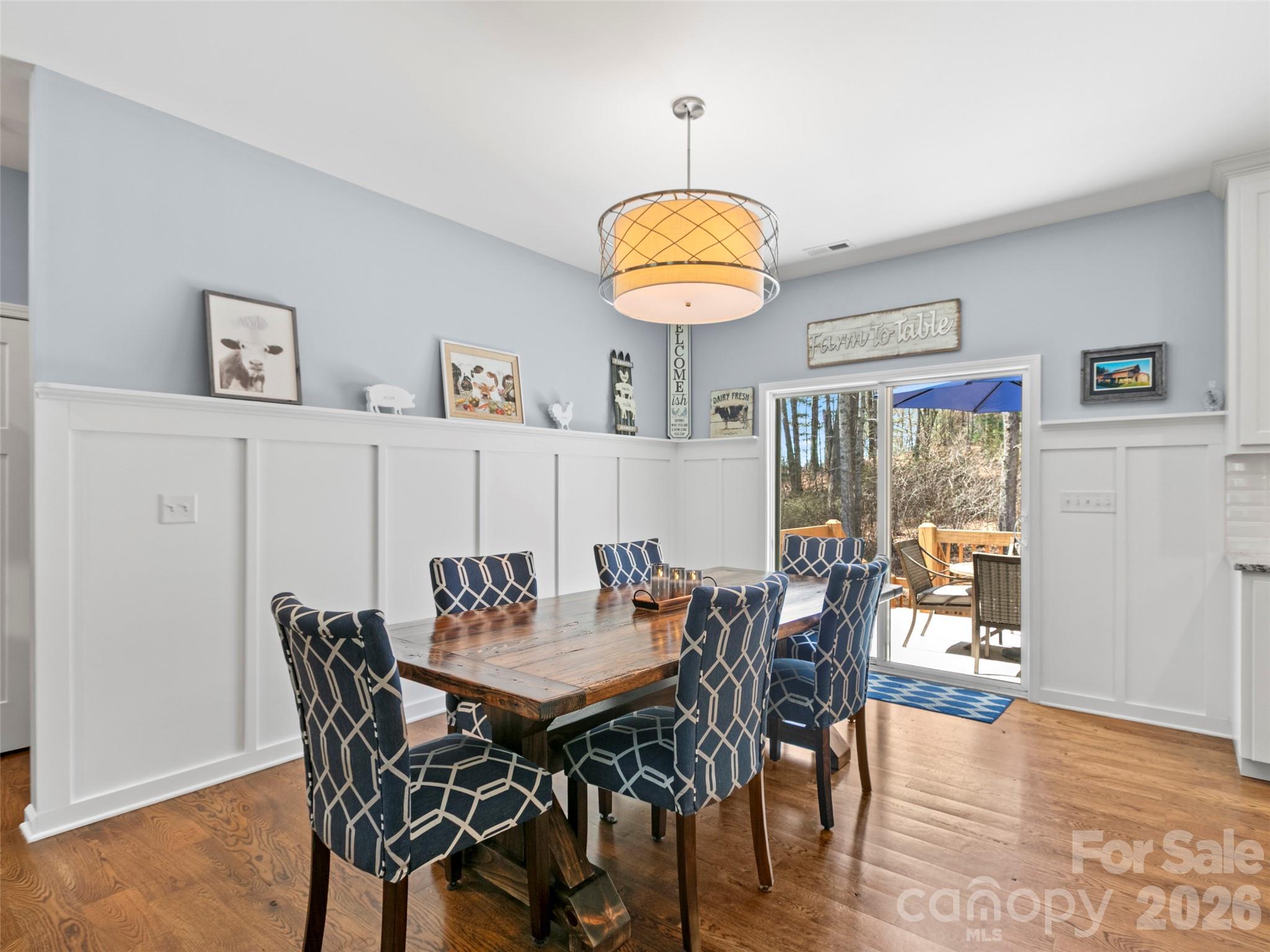 Open-concept dining area featuring a custom accent wall and built-in shelving, creating a stylish focal point for everyday meals and entertaining - 290 Sweetwater Hills Drive, Hendersonville